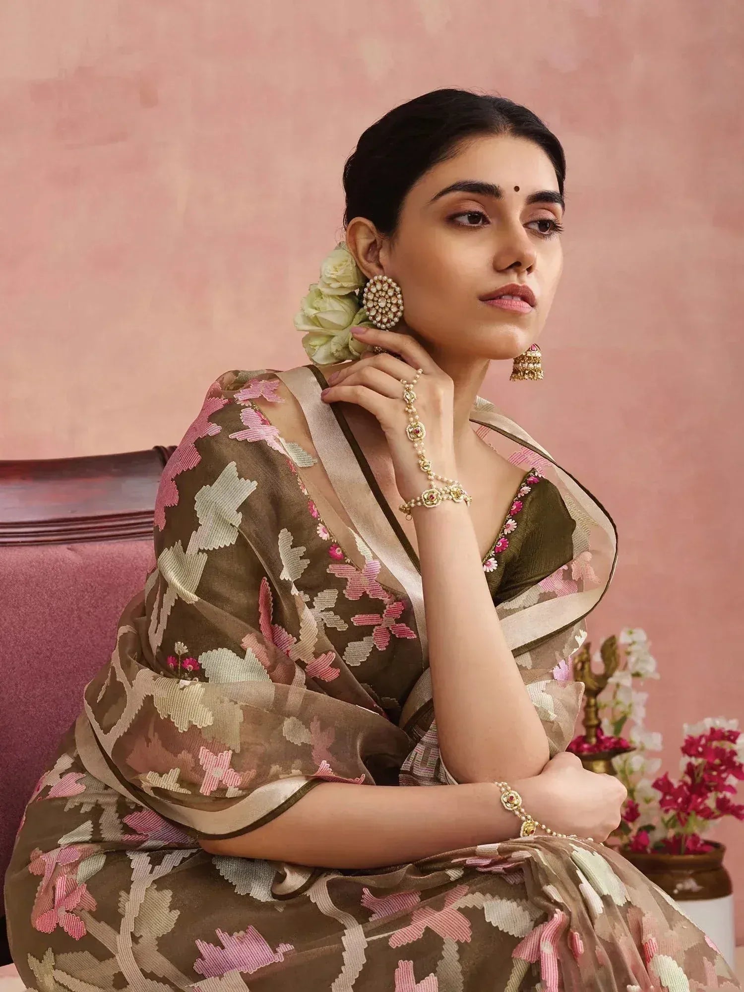 Woman in elegant floral embroidered saree with gold jewelry, styled for Indian ethnic wear occasions