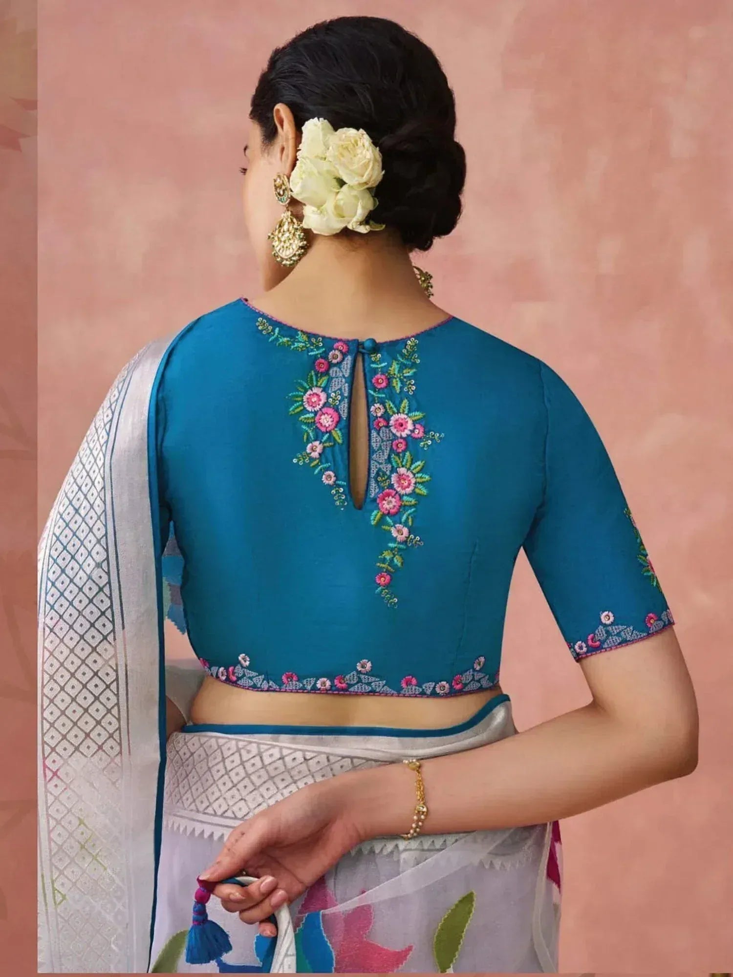 Blue embroidered saree blouse with floral back design and white saree, perfect for Indian ethnic wear