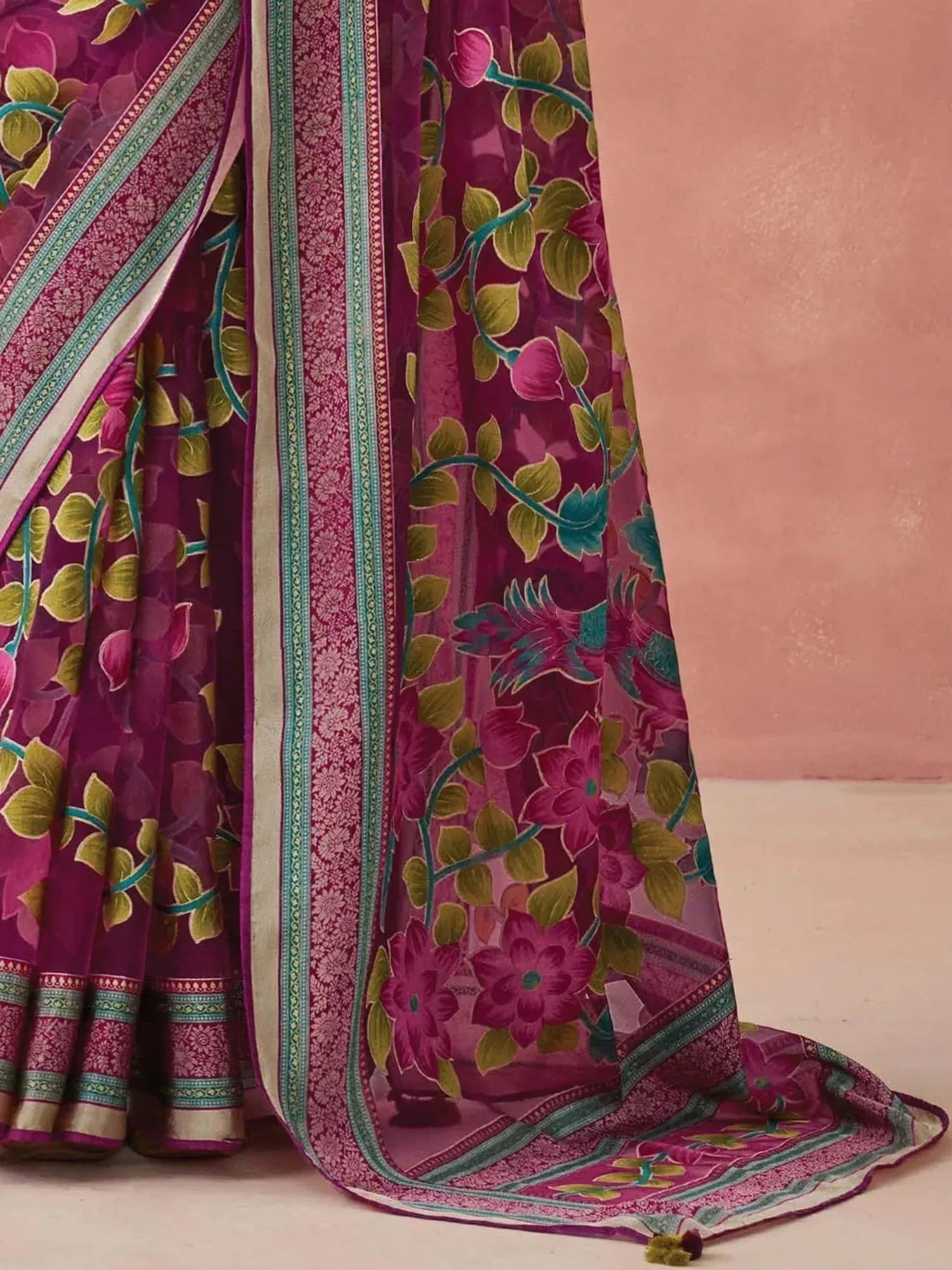 Purple floral print saree with green leaf motifs and intricate border design