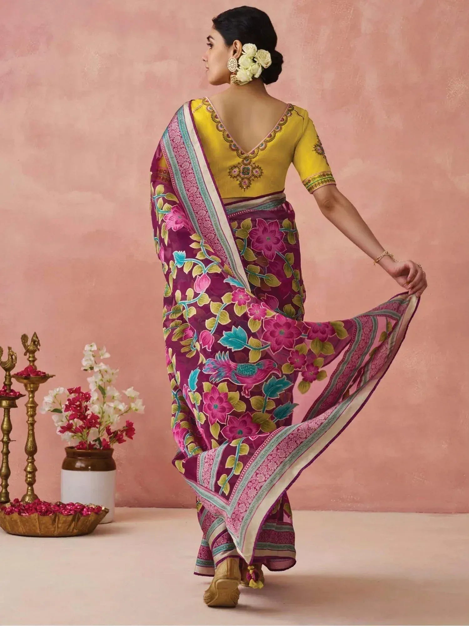 Woman in vibrant floral purple saree with yellow embroidered blouse, traditional Indian ethnic wear