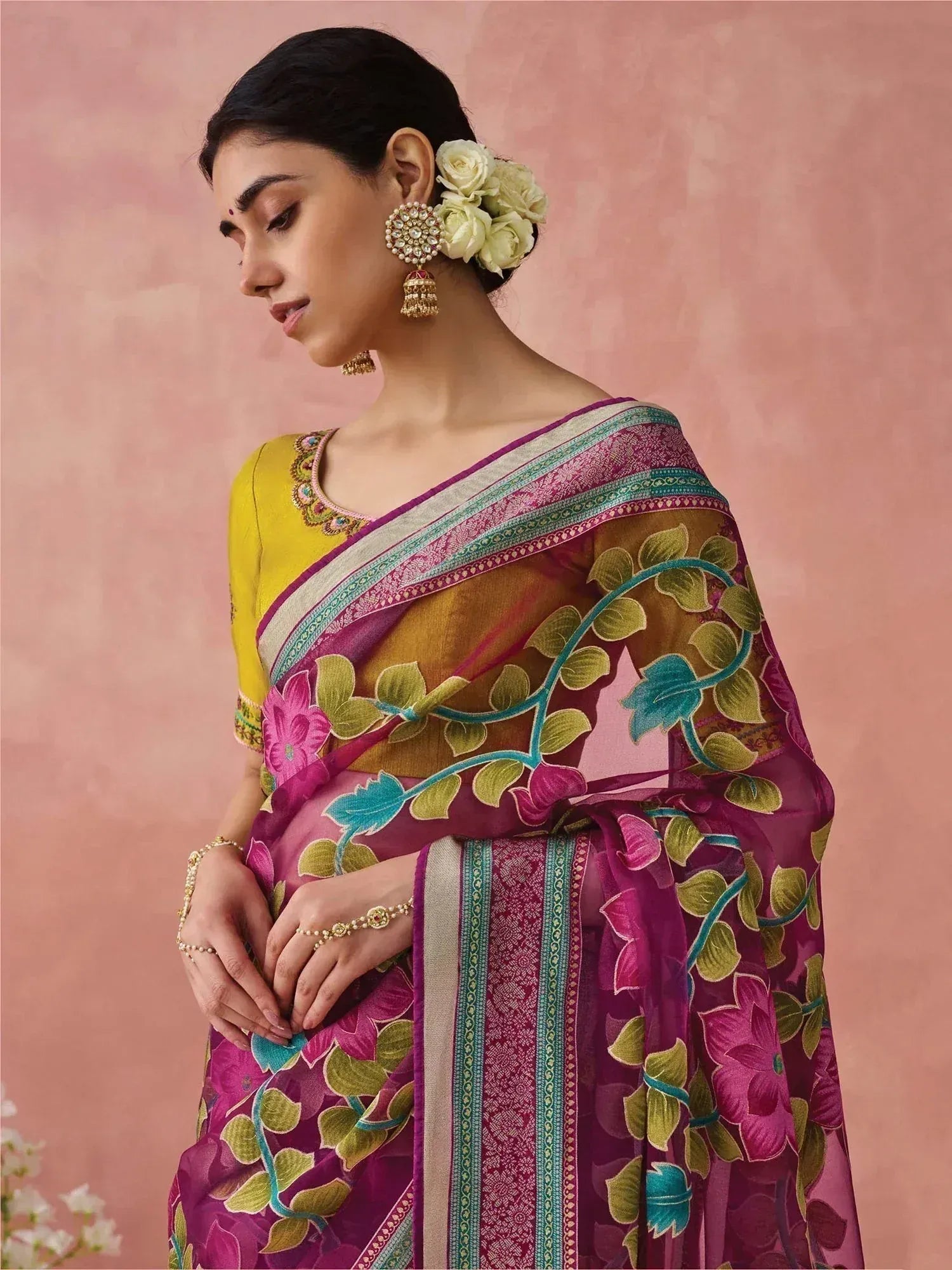 Woman in vibrant floral saree with yellow blouse, traditional Indian ethnic wear, perfect for festive occasions.