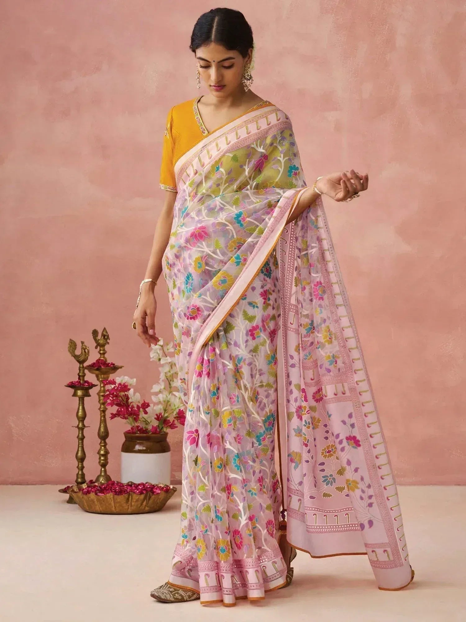 Woman in floral printed pastel saree with yellow blouse, ethnic Indian wear for festive occasions