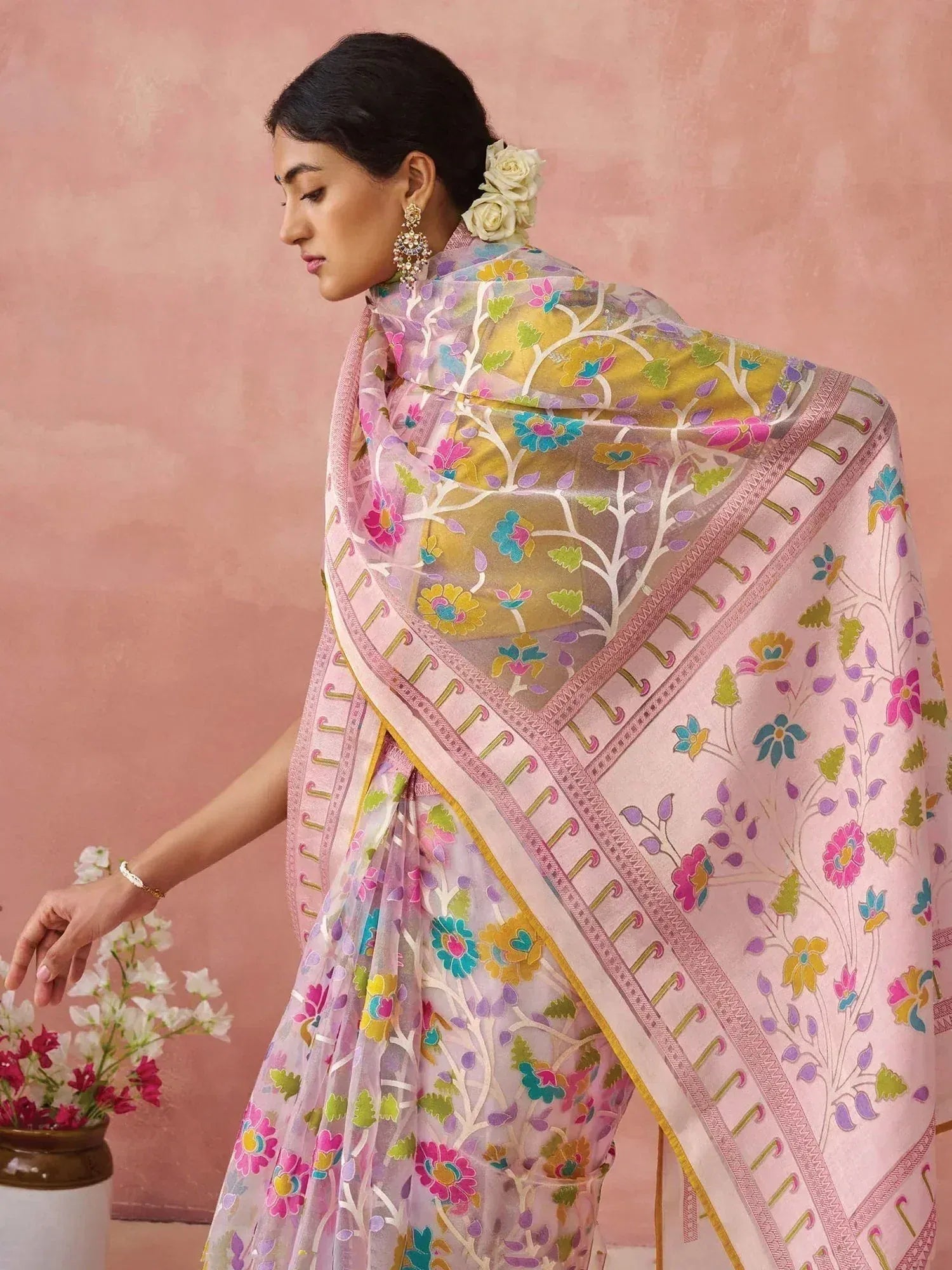 Woman in floral printed saree with pink border, ethnic Indian wear, designer saree style