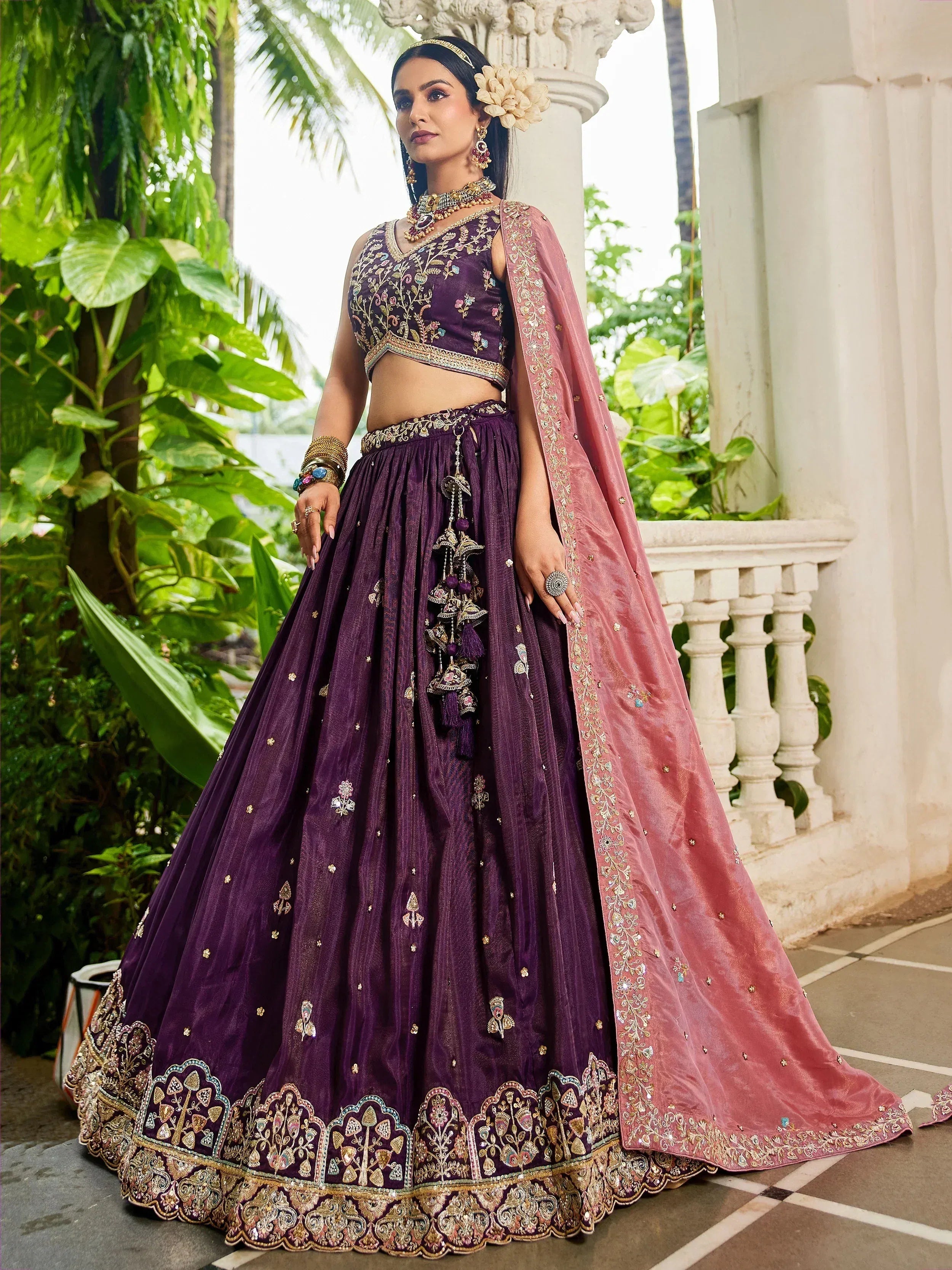 Elegant purple embroidered lehenga choli with pink dupatta, perfect for Indian weddings and festive occasions.