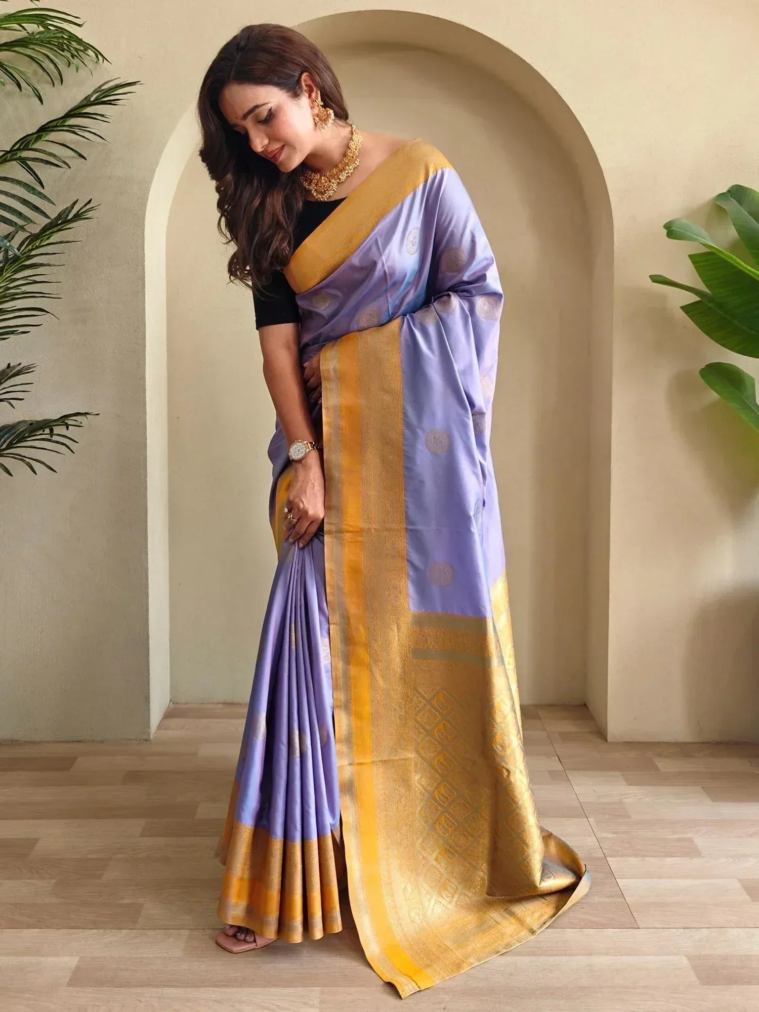 Woman in elegant lavender and gold silk saree with intricate border, perfect for Indian ethnic occasions