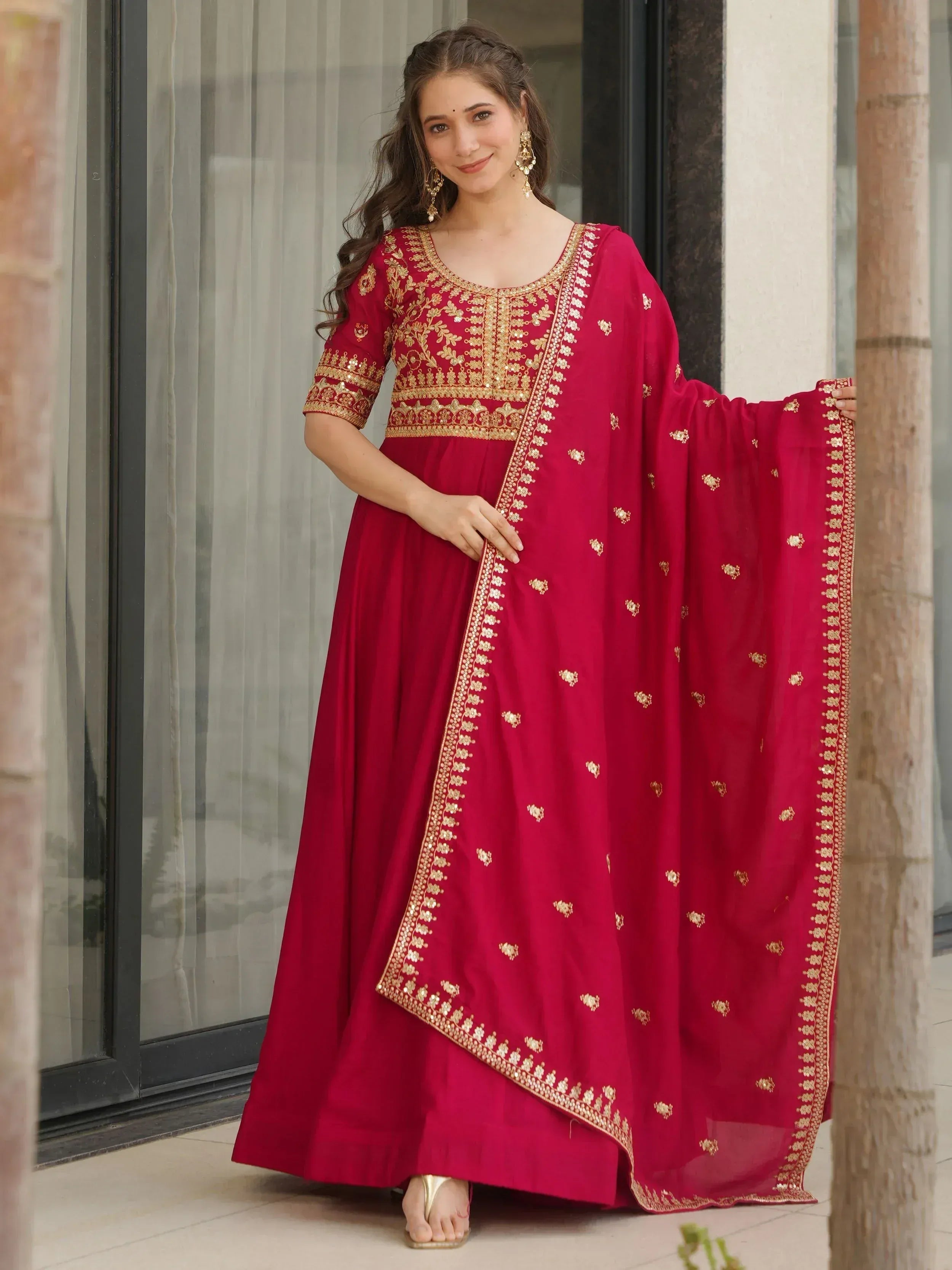 Red ethnic gown with gold embroidery, perfect for Indian occasions and festive wear