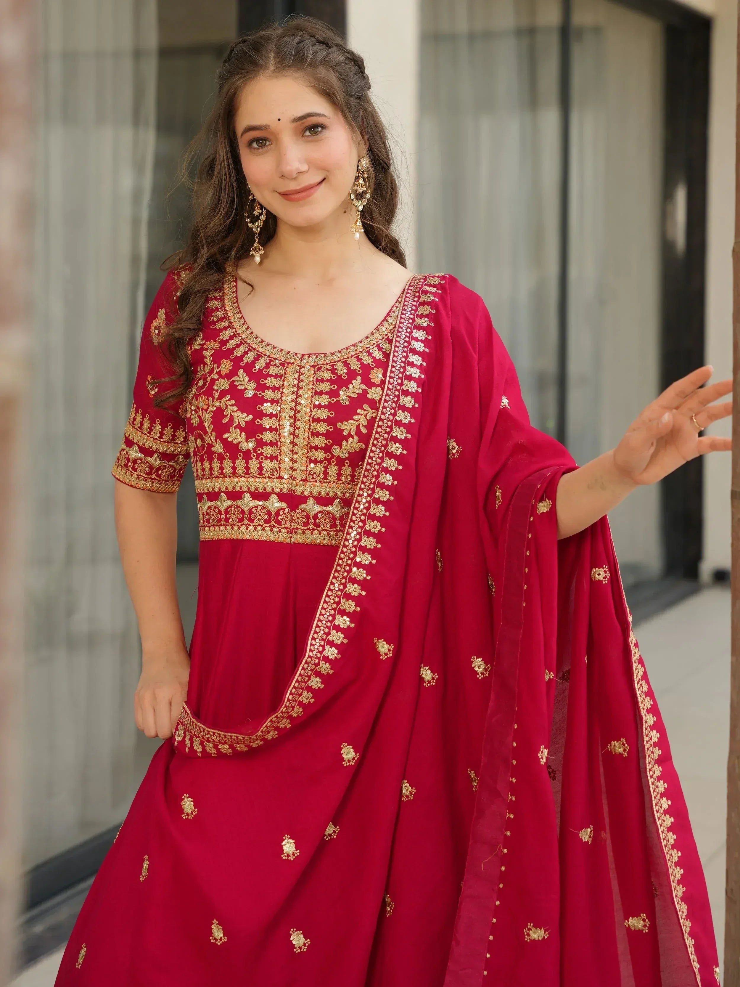 Red ethnic anarkali suit with gold embroidery, perfect for Indian weddings and festive occasions