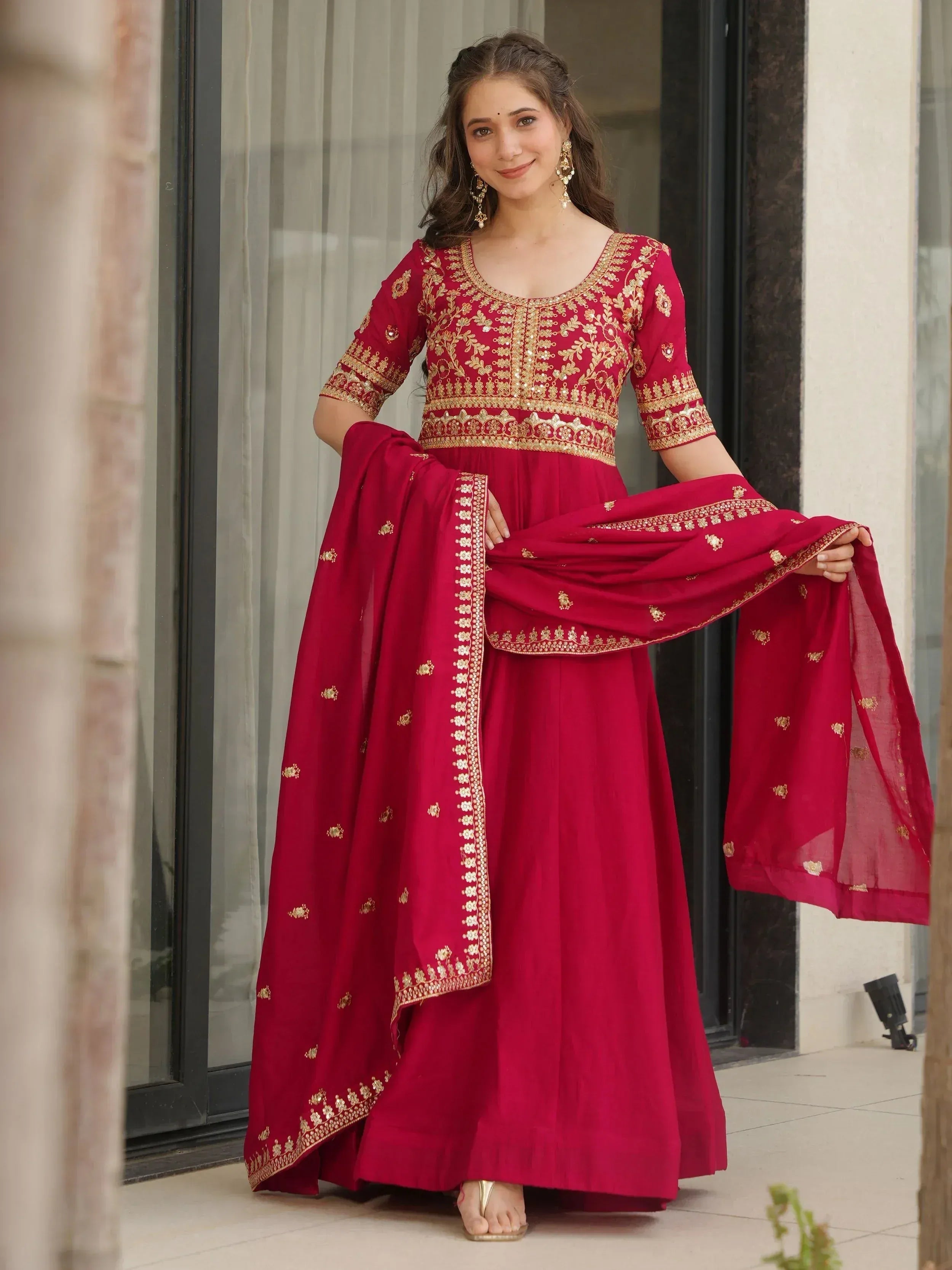 Red embroidered Indian anarkali suit with gold detailing, perfect for festive occasions and weddings.
