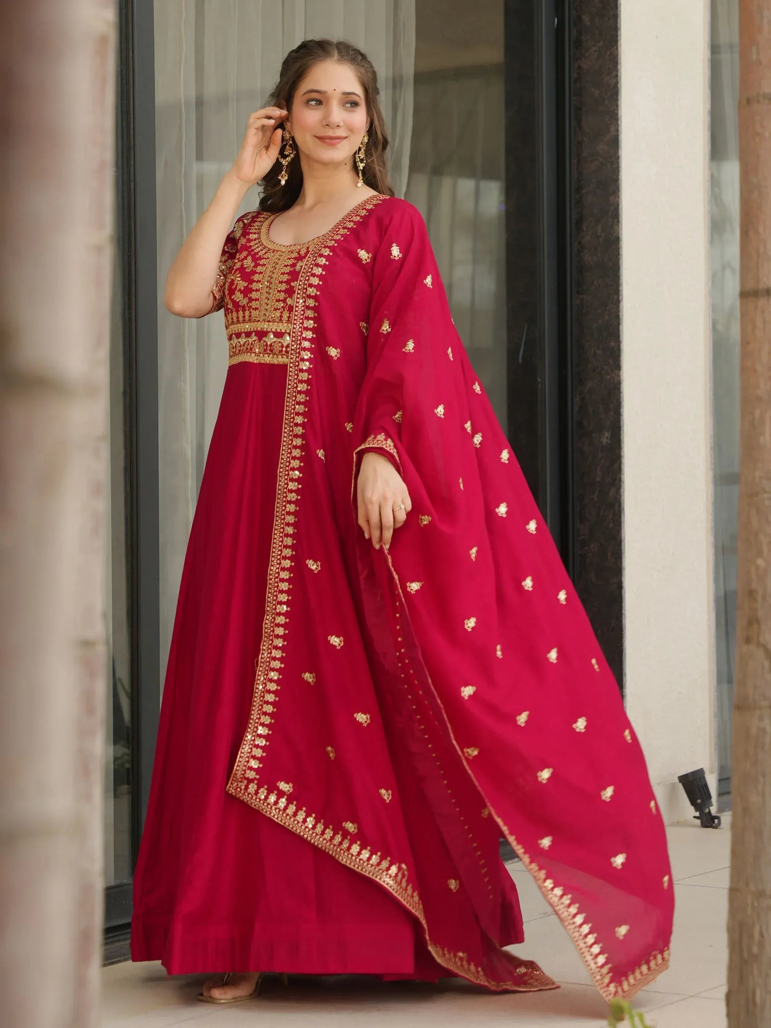 Red ethnic anarkali suit with gold embroidery, perfect for Indian weddings and festive occasions