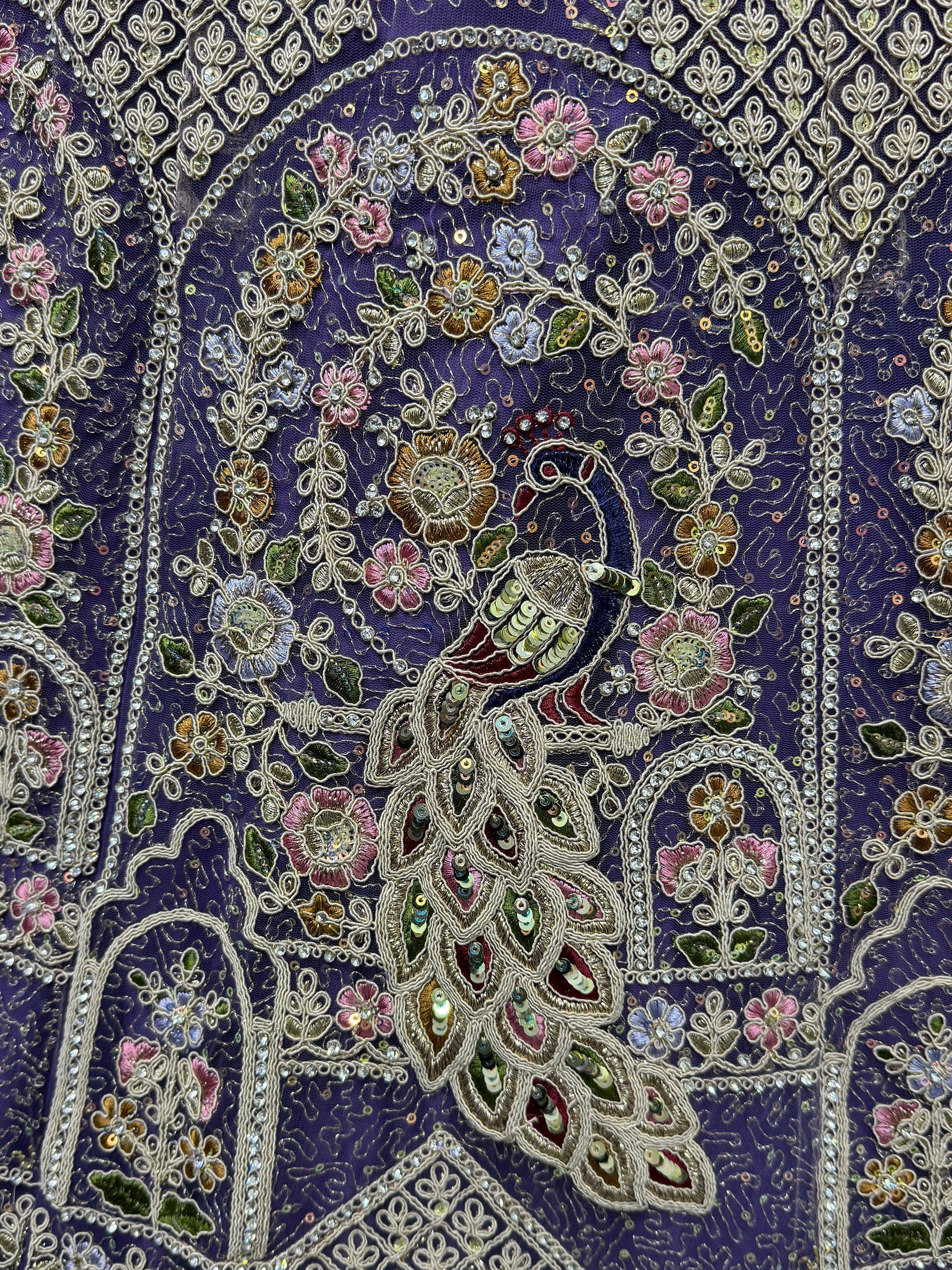Purple ethnic wear with intricate peacock and floral embroidery, sequins, and beadwork for designer lehenga or saree.