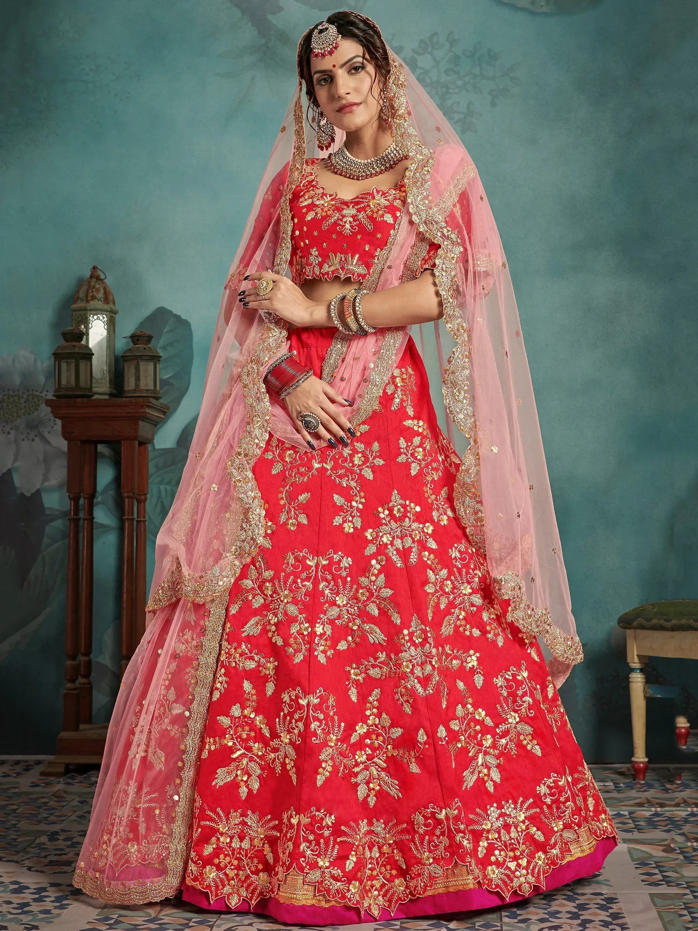 Red and pink embroidered lehenga choli with gold floral work and matching dupatta for Indian weddings