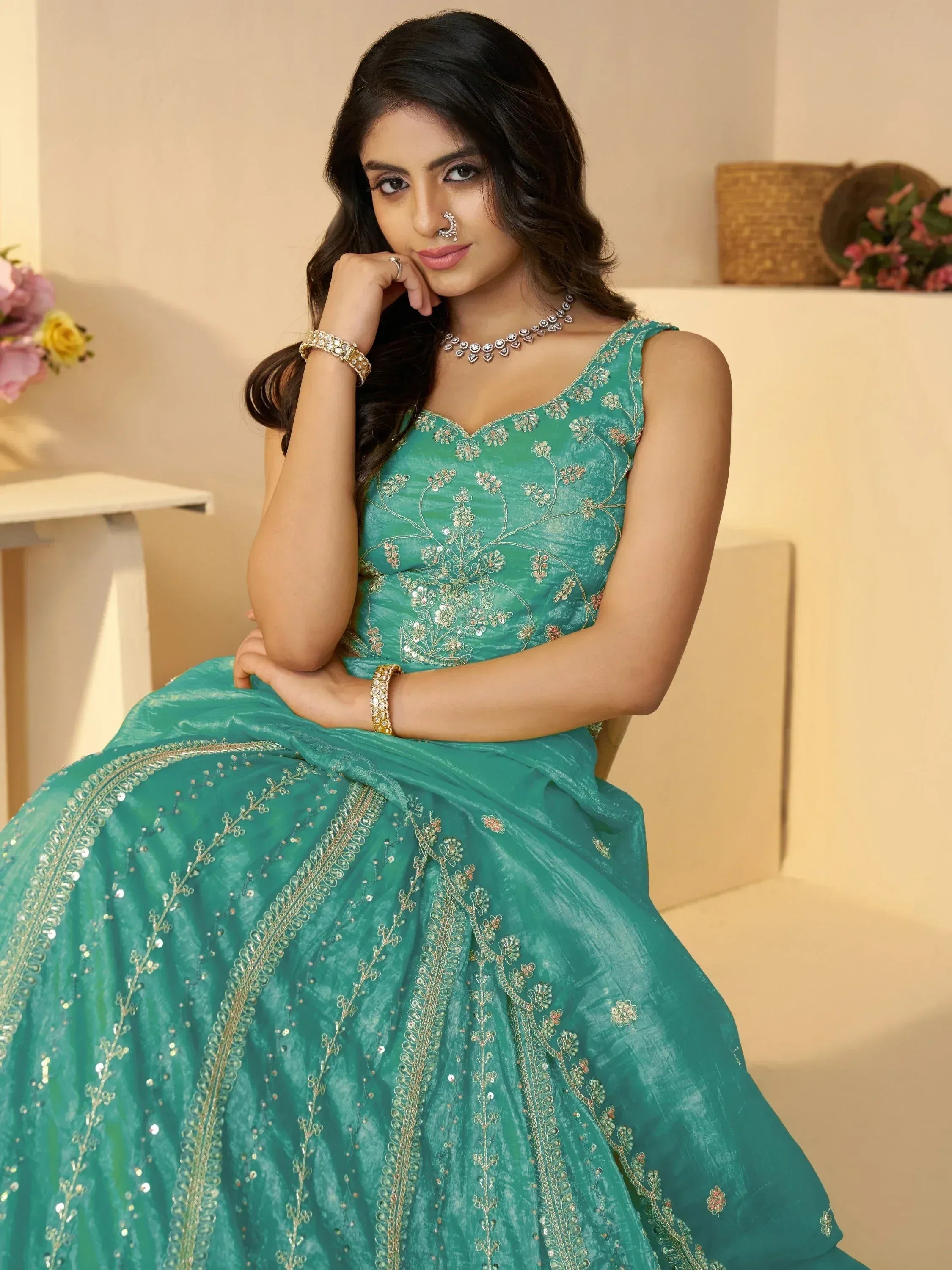 Teal embroidered lehenga choli with gold floral detailing, perfect for Indian ethnic wear occasions.