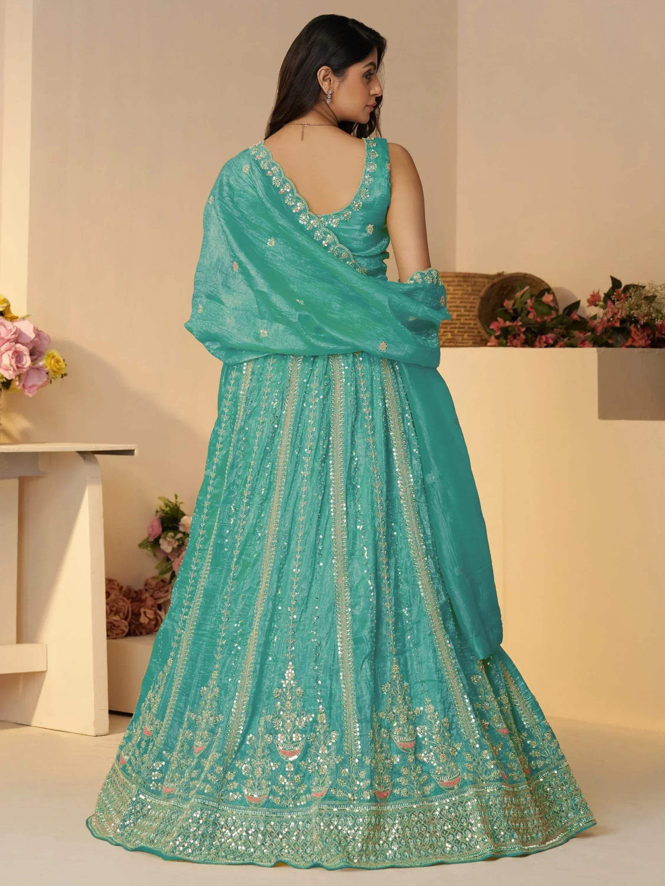 Teal designer lehenga choli with gold embroidery and sequins, ethnic Indian wear for weddings