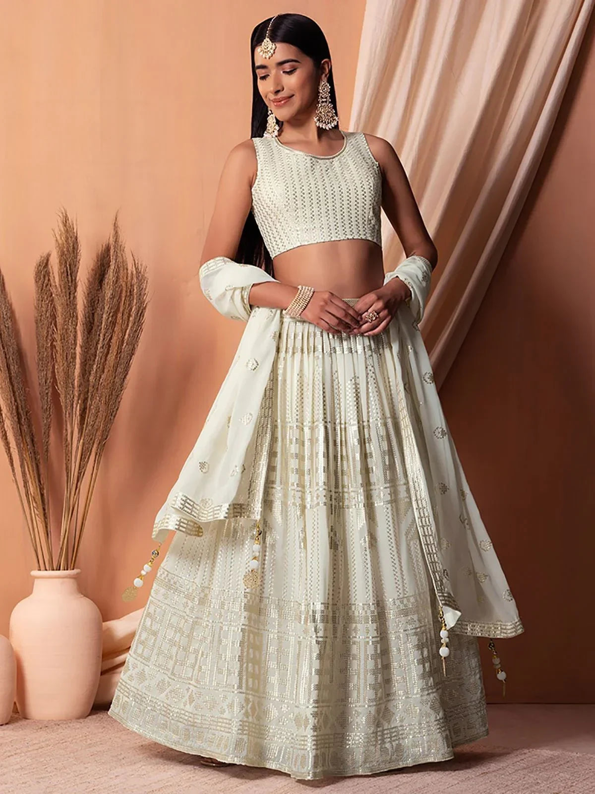 Elegant off-white lehenga choli with gold embroidery, perfect for Indian ethnic wear and festive occasions.