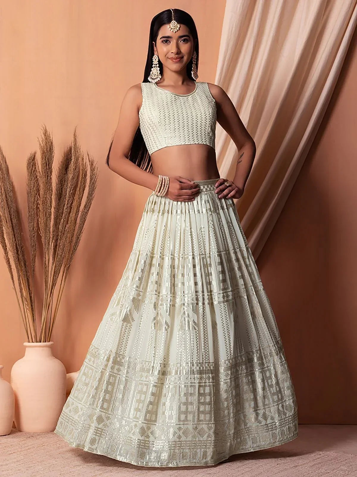 Elegant off-white lehenga choli with intricate embroidery, perfect for Indian ethnic wear occasions.