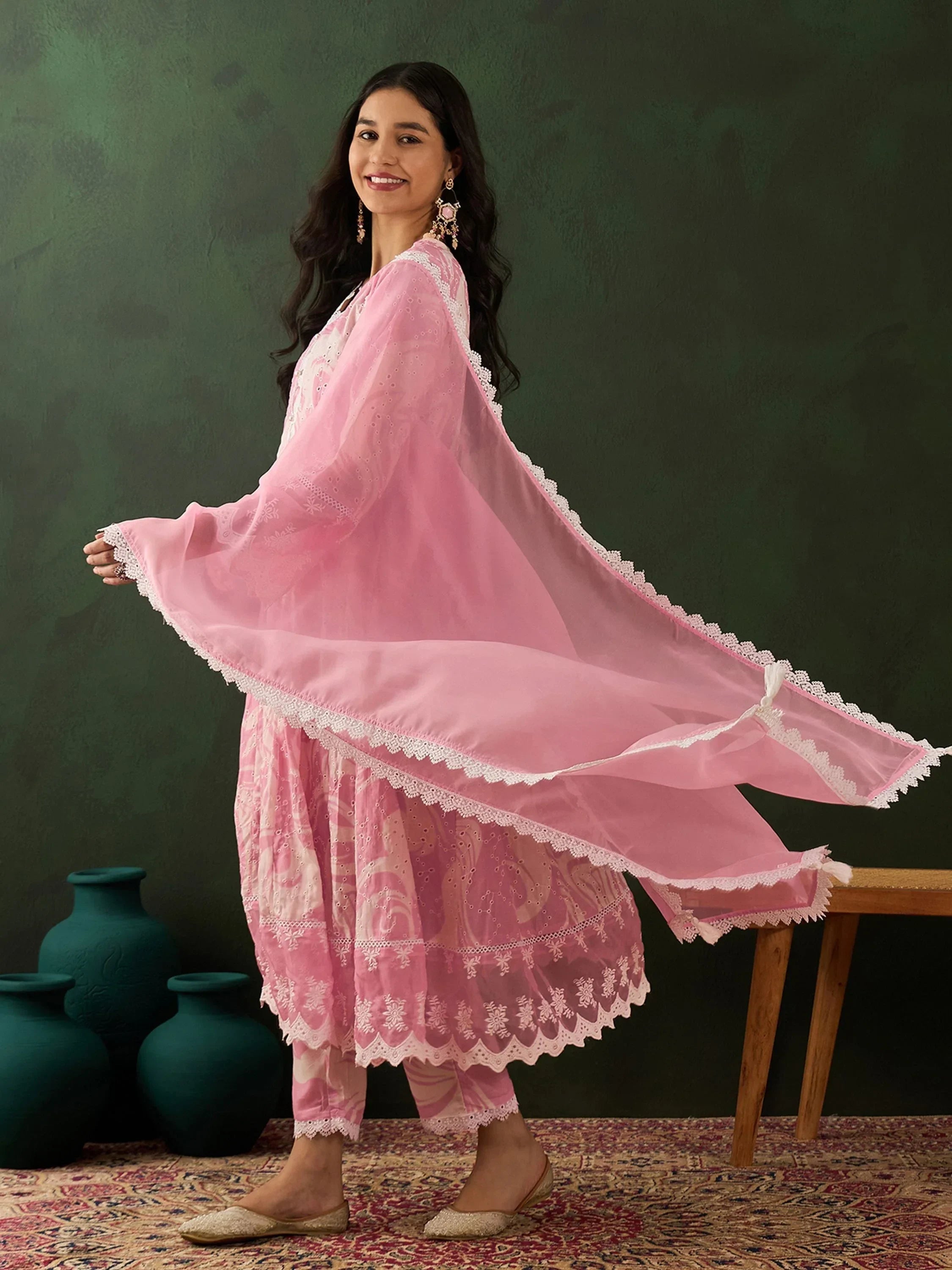 Woman in pink embroidered salwar kameez with dupatta, ethnic Indian outfit