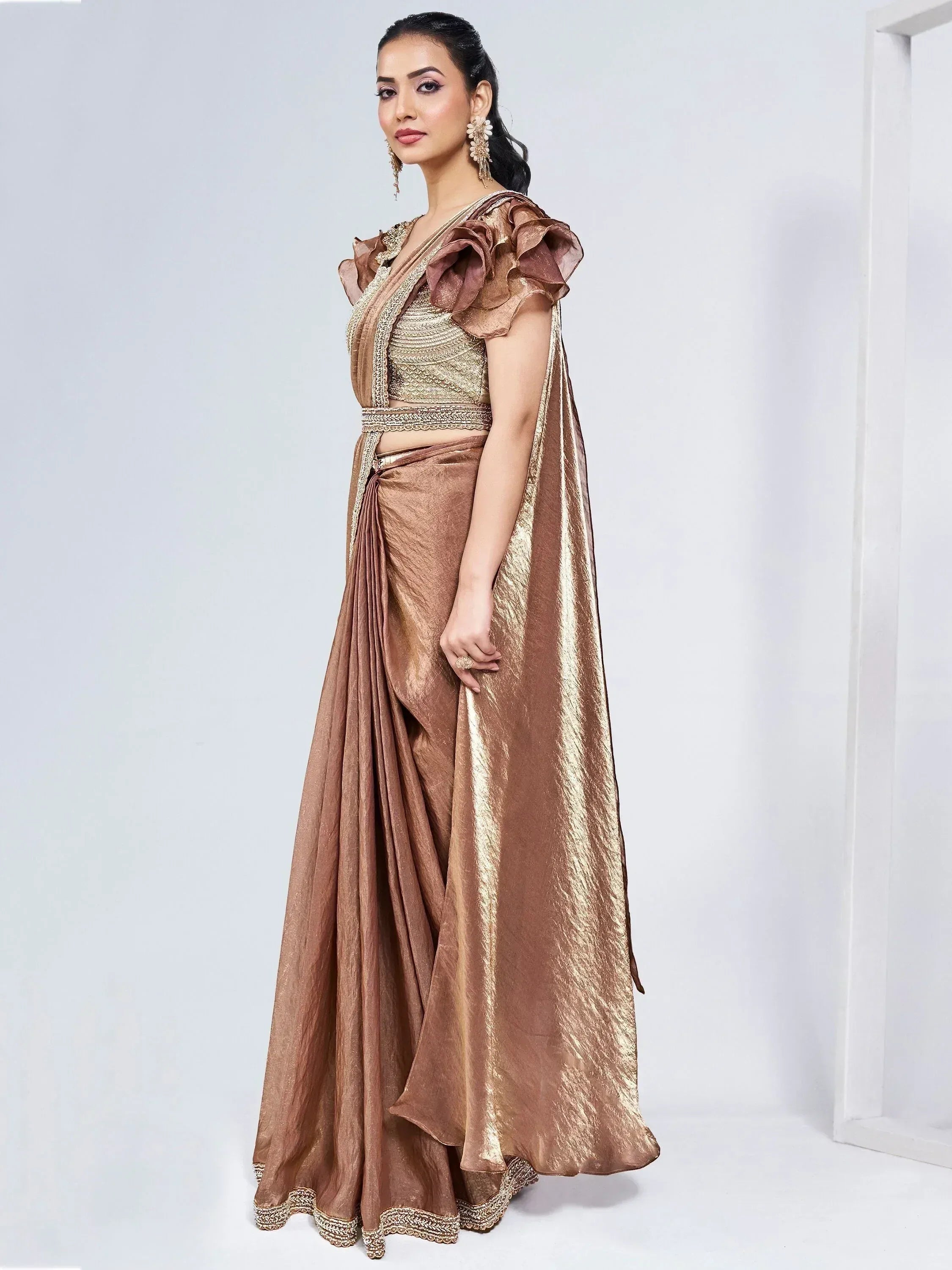 Elegant gold lehenga choli with ruffled sleeves and embroidered detailing, perfect for Indian ethnic wear occasions.