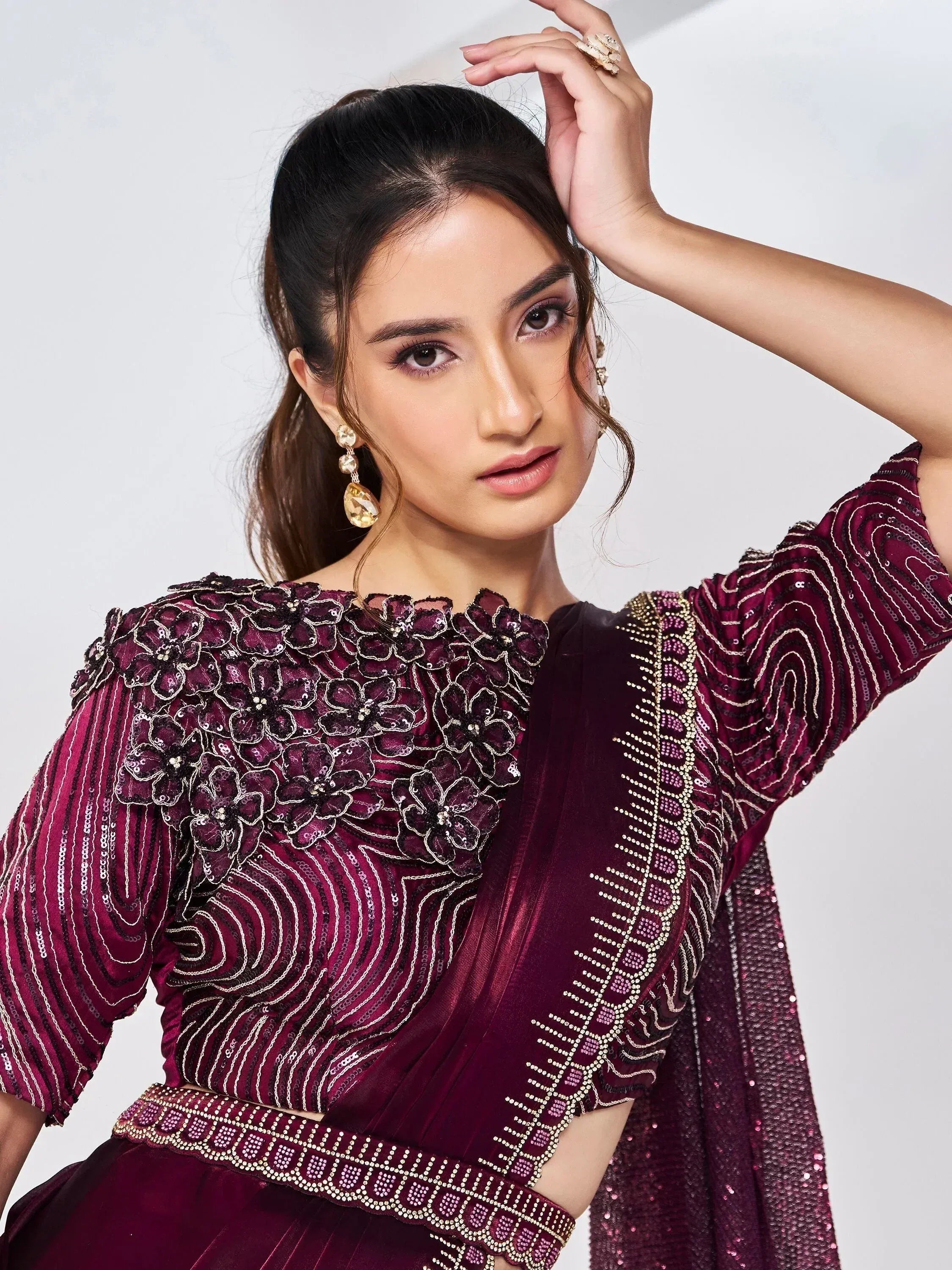 Elegant maroon ethnic gown with floral embroidery and sequin detailing for festive occasions