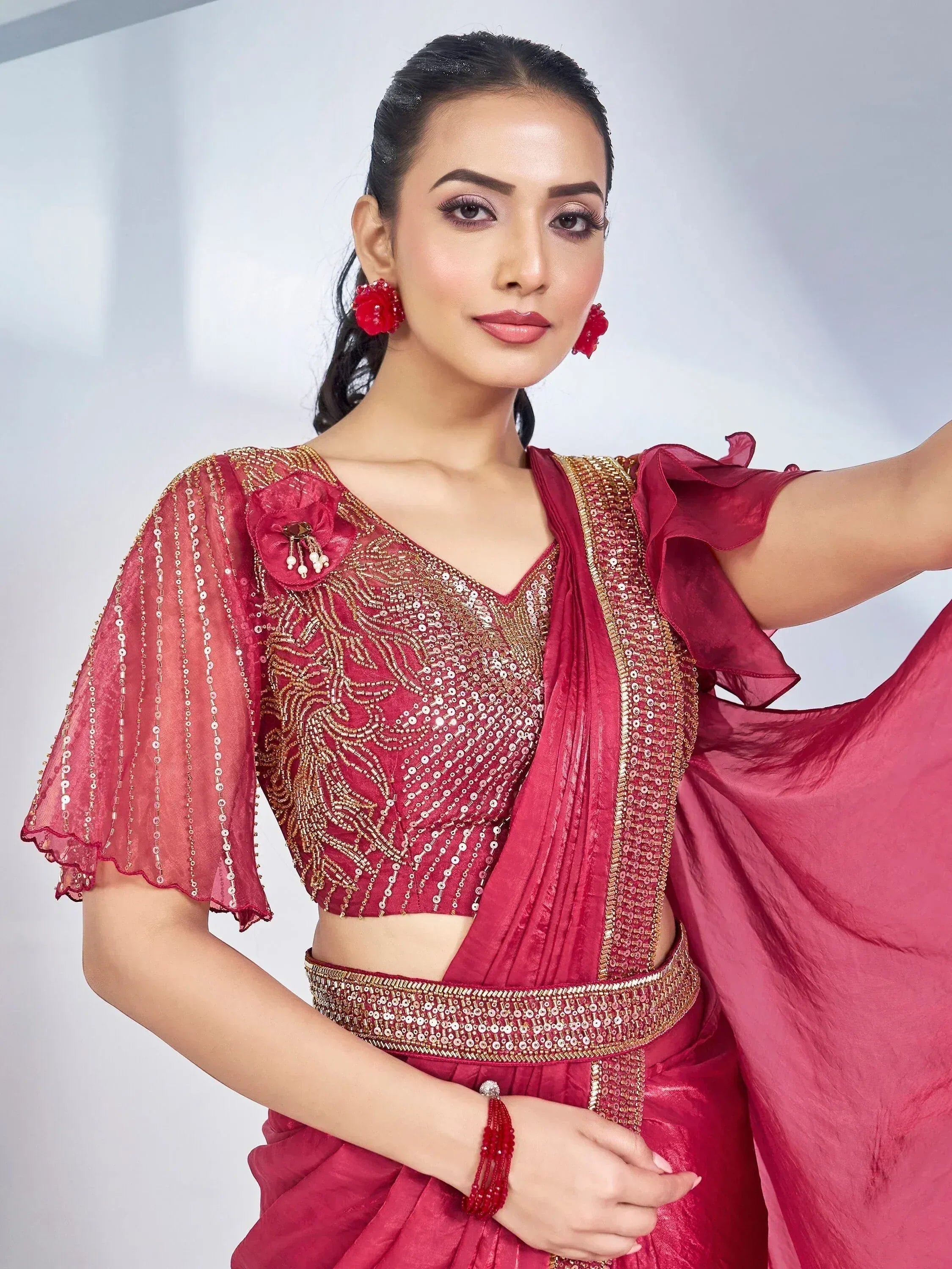 Red designer lehenga choli with gold sequin embroidery and ruffle sleeves, perfect for Indian ethnic occasions