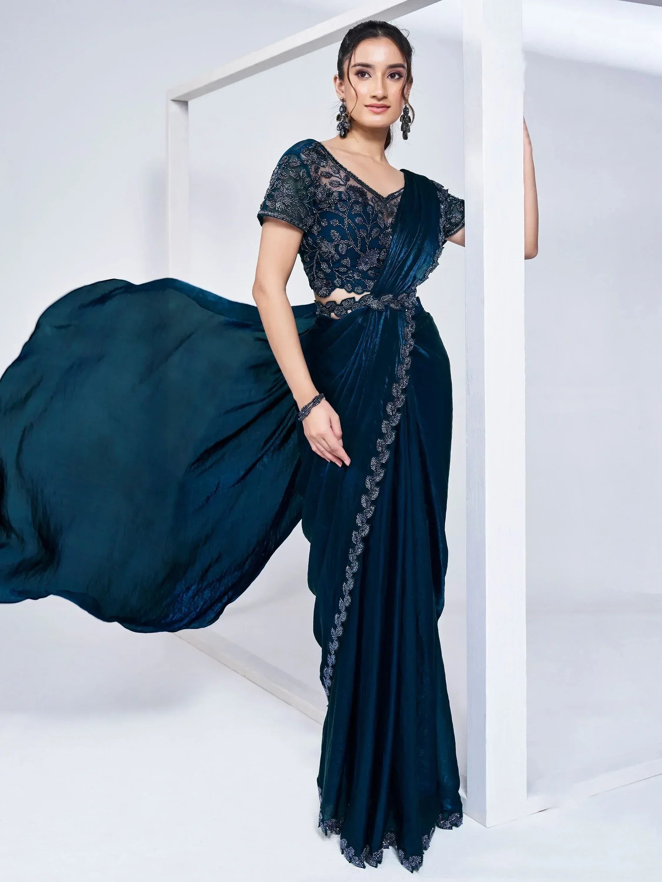 Elegant dark green velvet saree with embroidered blouse, perfect for Indian ethnic wear occasions