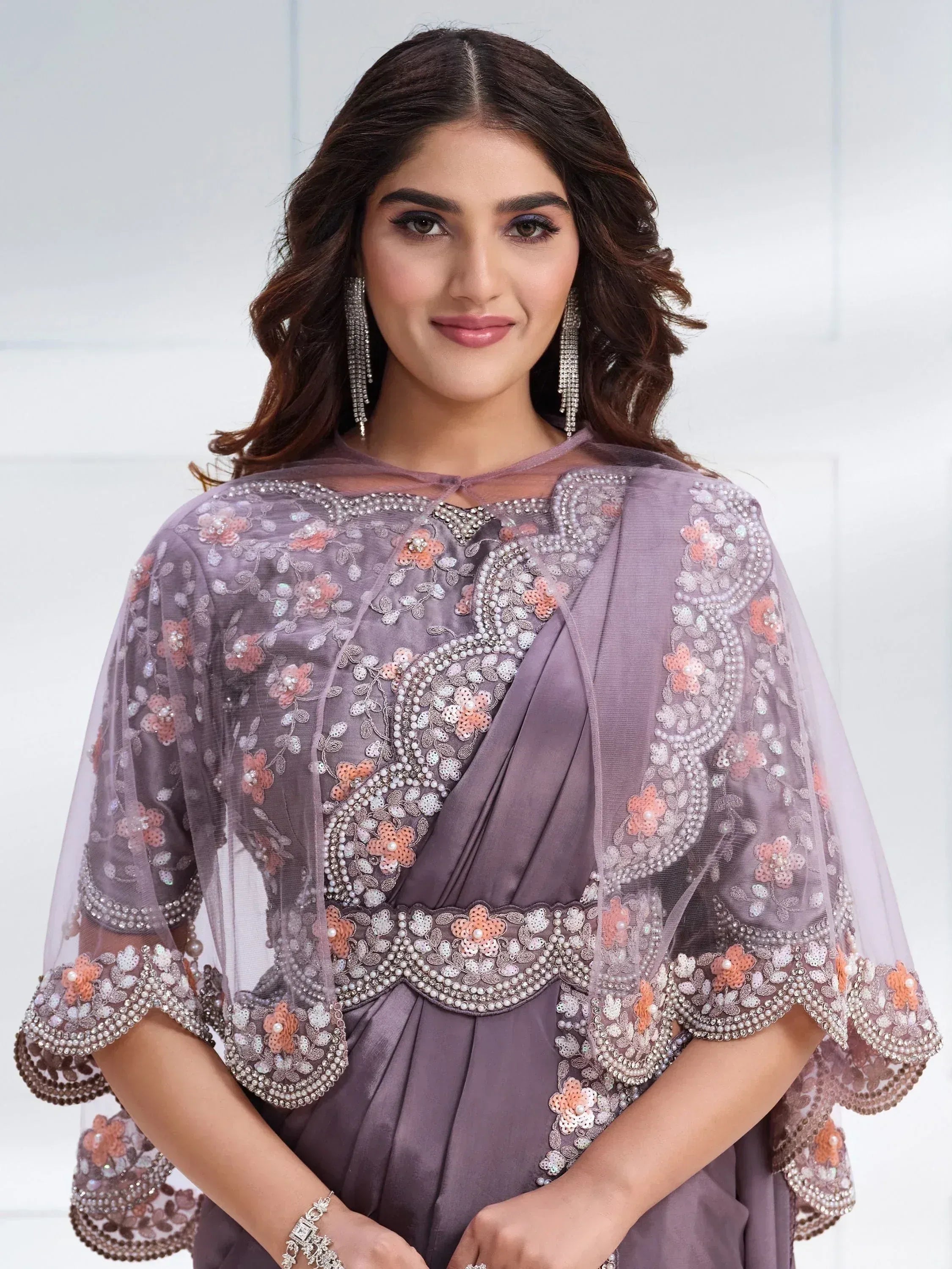 Elegant purple ethnic gown with floral embroidery and pearl detailing, perfect for Indian occasions
