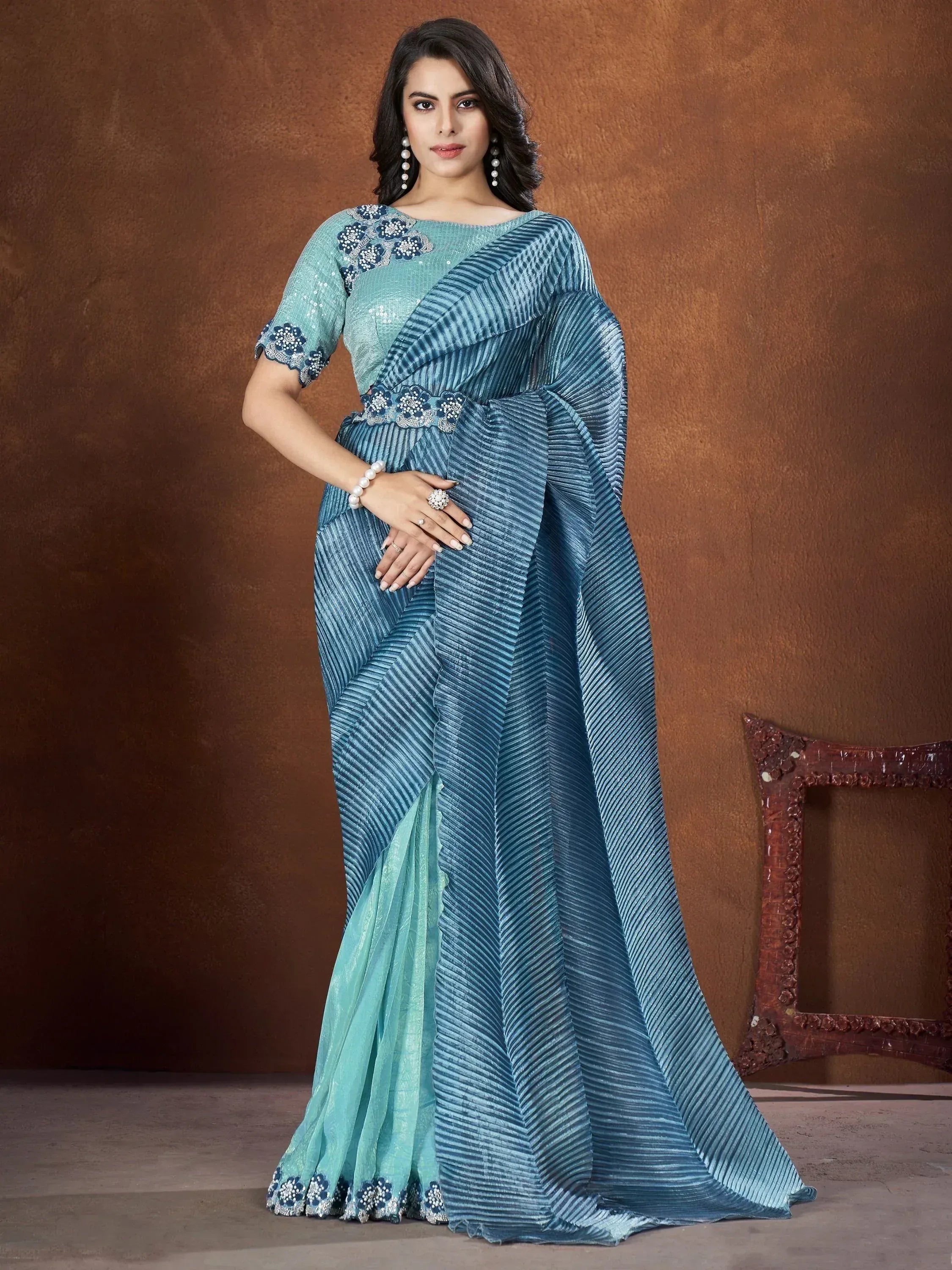Elegant blue pleated saree with floral embroidery, perfect for Indian ethnic wear occasions.
