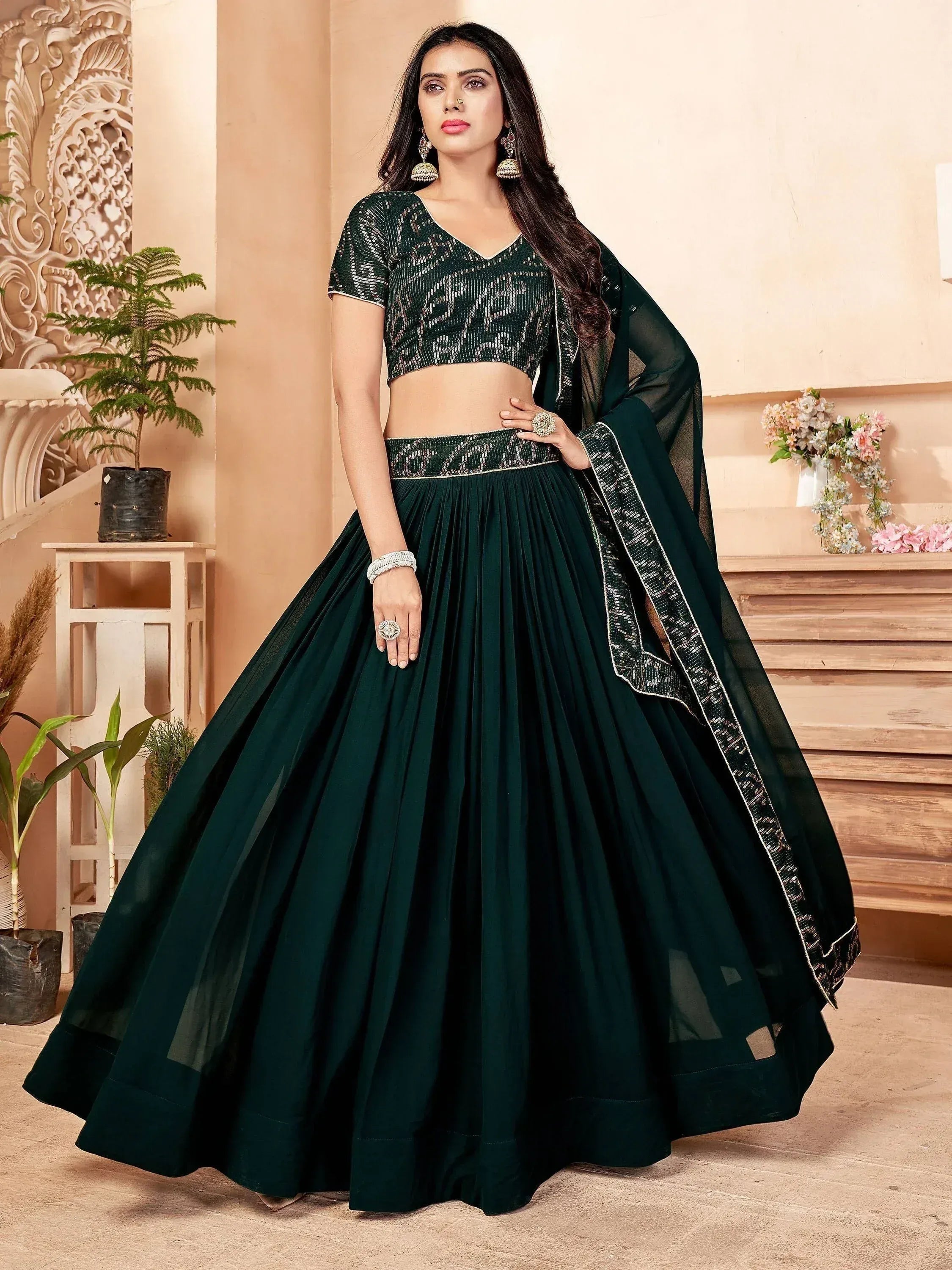 Emerald green designer lehenga choli with sequin blouse and pleated skirt, perfect for Indian ethnic wear occasions