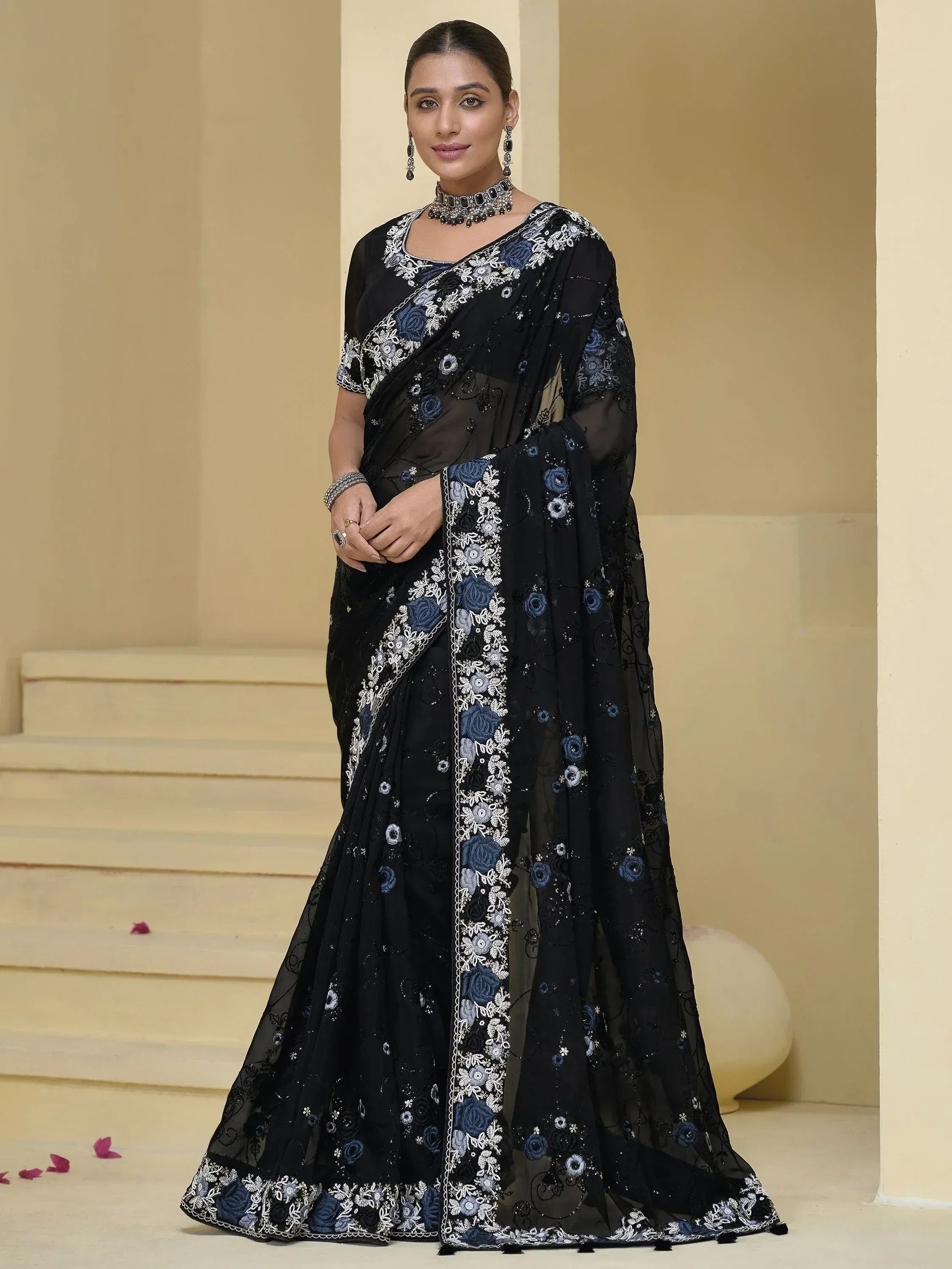 Black embroidered saree with blue floral design, perfect for Indian ethnic wear occasions