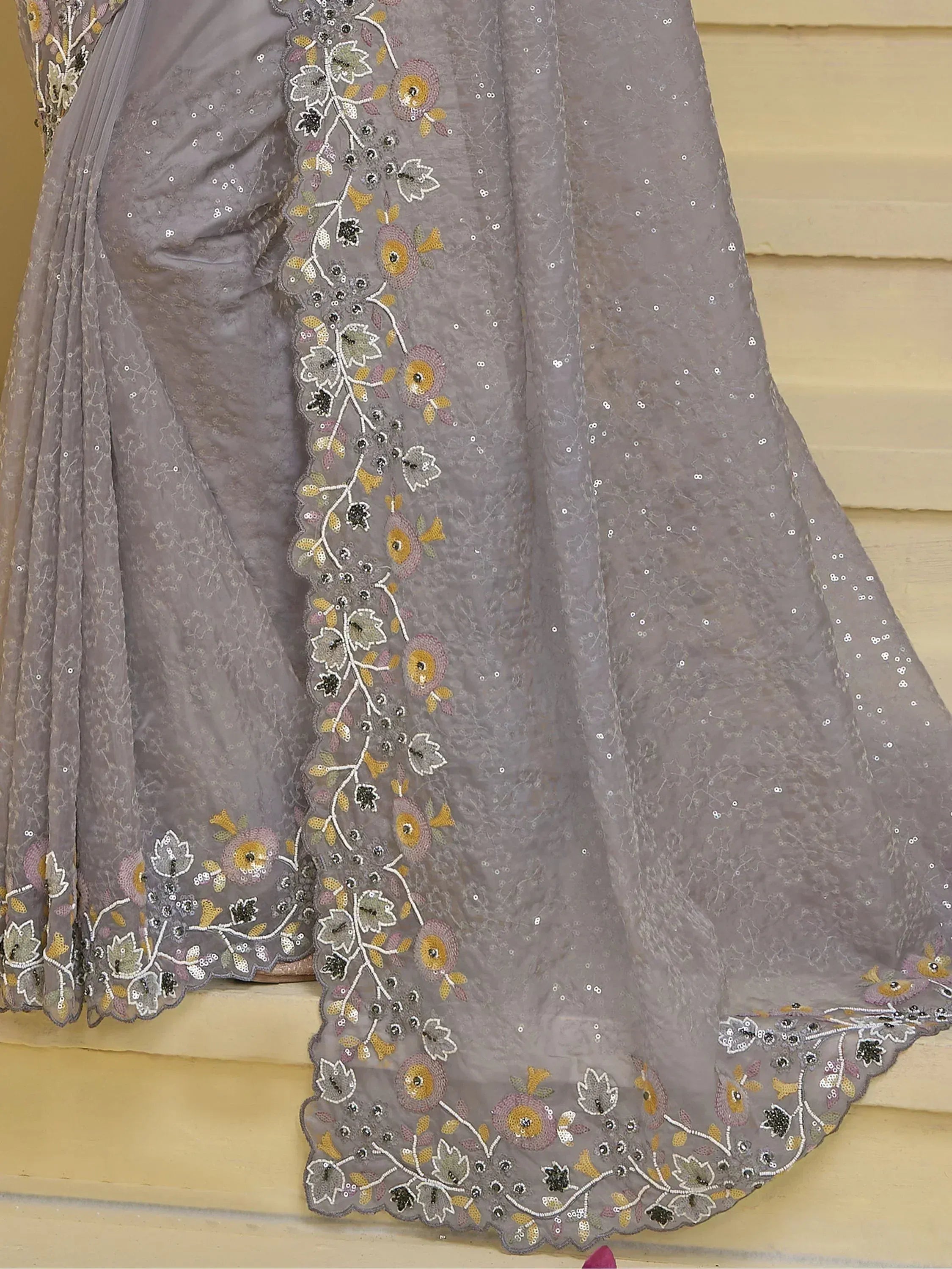 Grey designer saree with floral embroidery and sequin detailing, perfect for ethnic occasions.