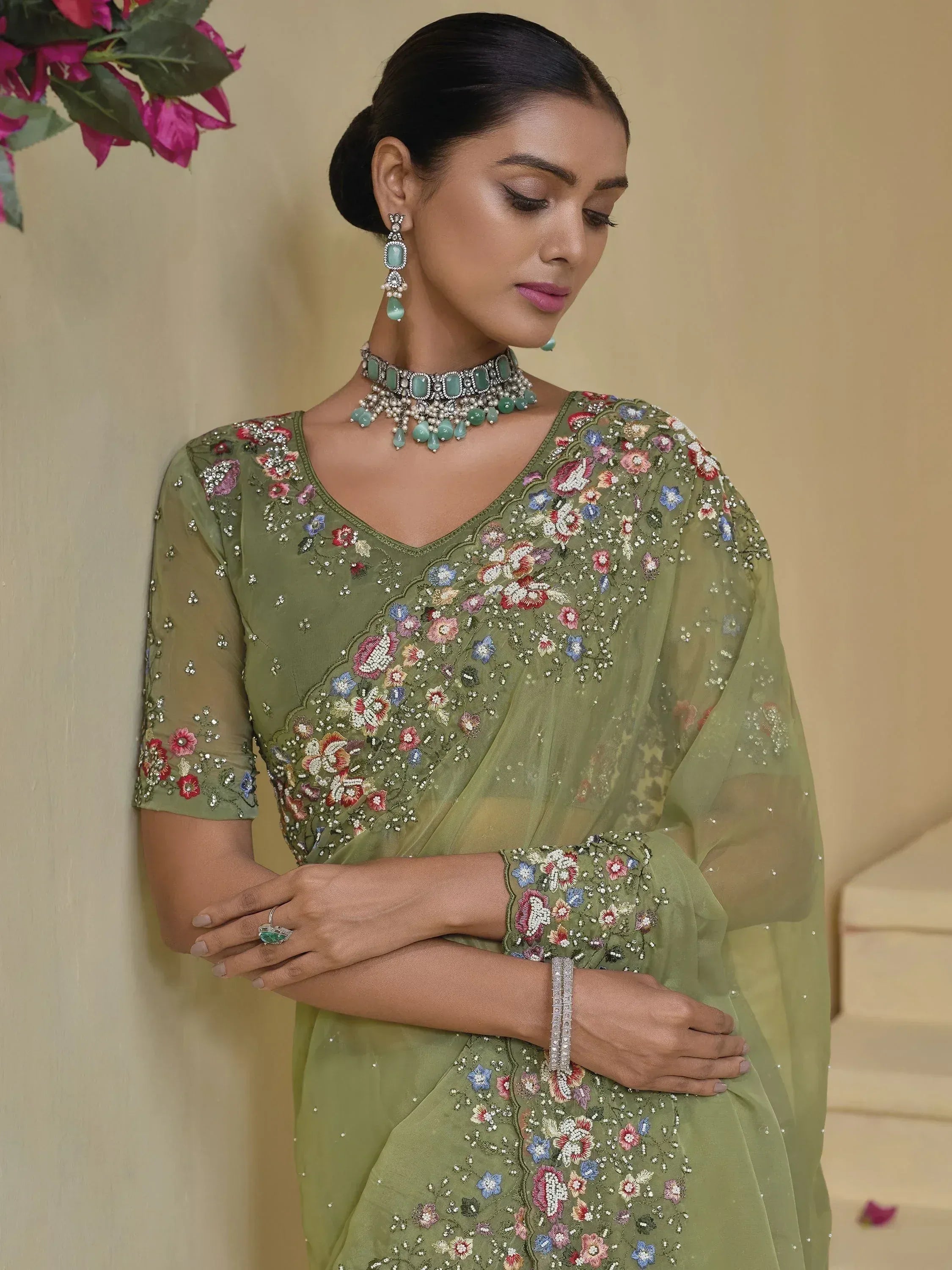 Olive green floral embroidered saree with matching jewelry, perfect for Indian ethnic occasions.