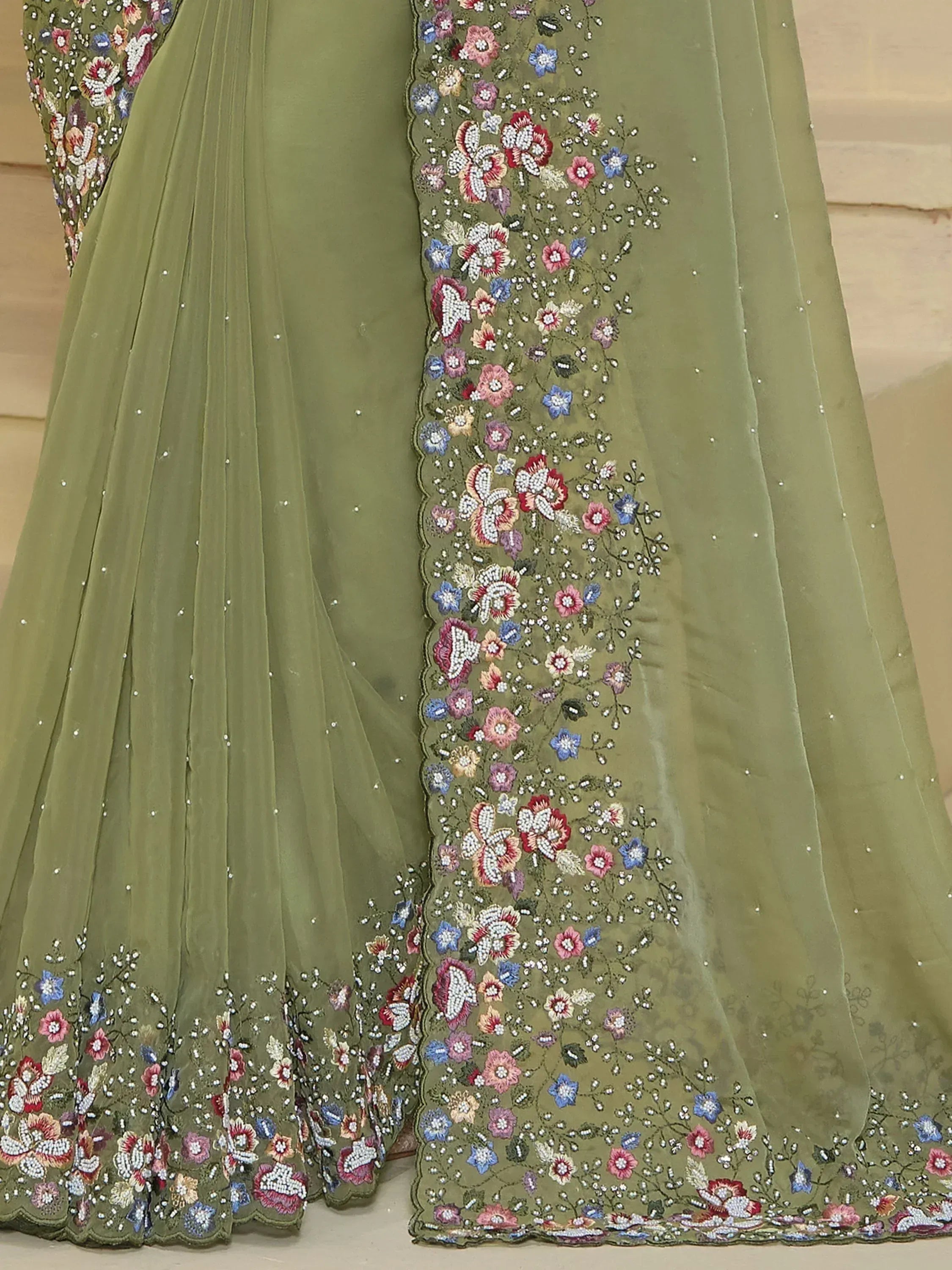 Olive green ethnic gown with floral embroidery and beadwork, perfect for Indian occasions