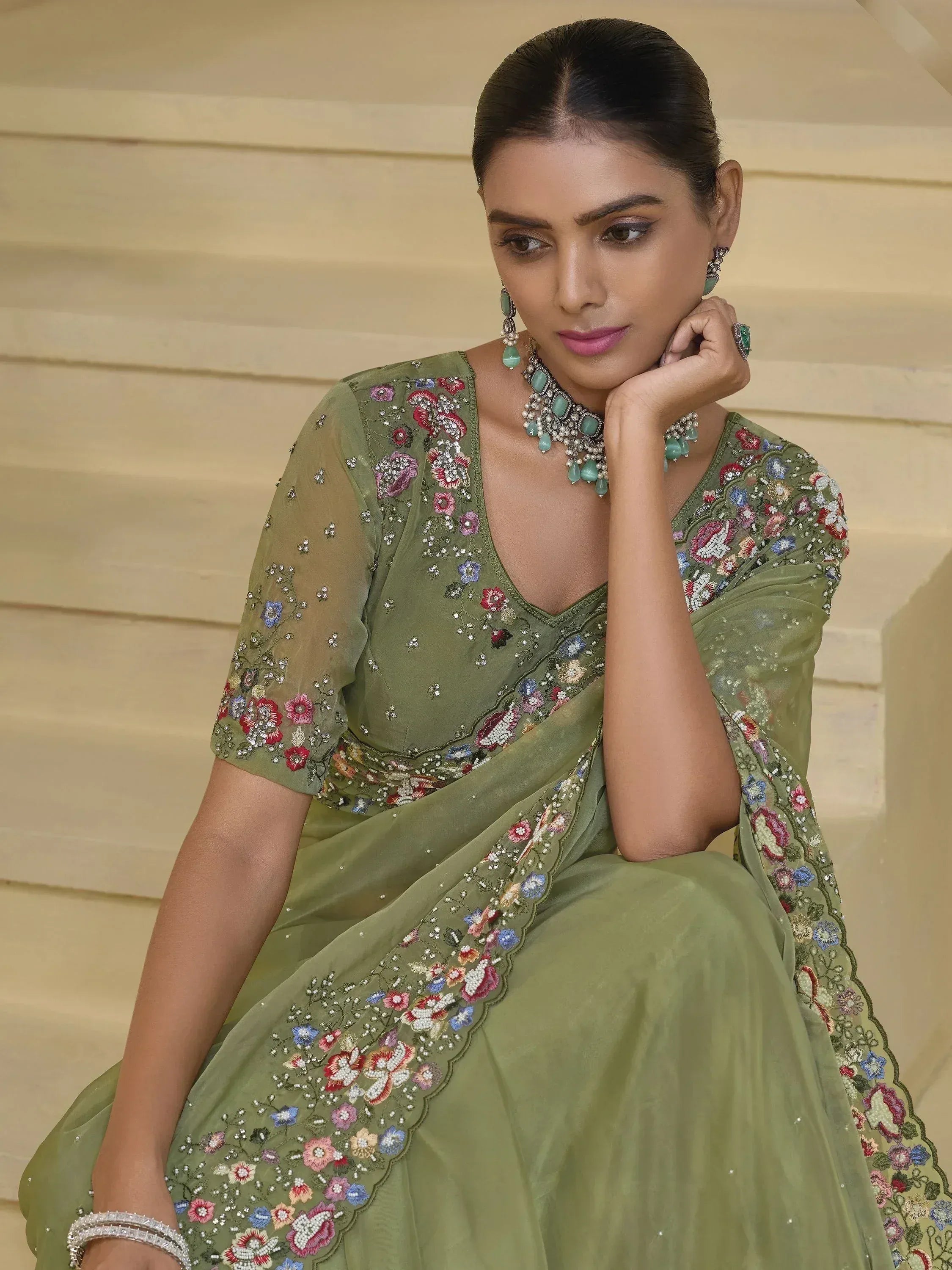 Olive green embroidered saree with floral motifs, perfect for Indian ethnic wear occasions.