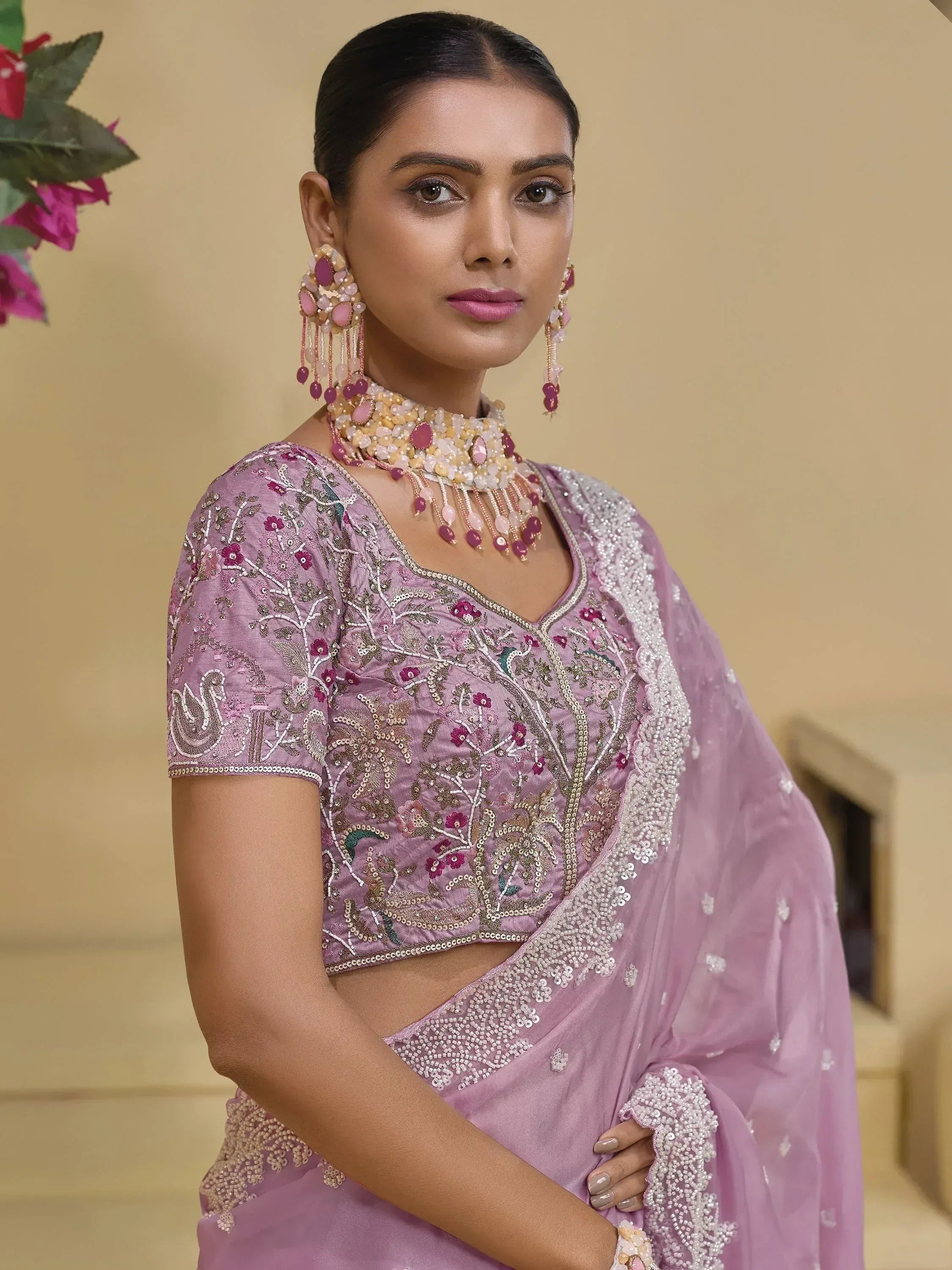 Elegant lavender embroidered saree with floral motifs and matching jewelry for Indian ethnic wear