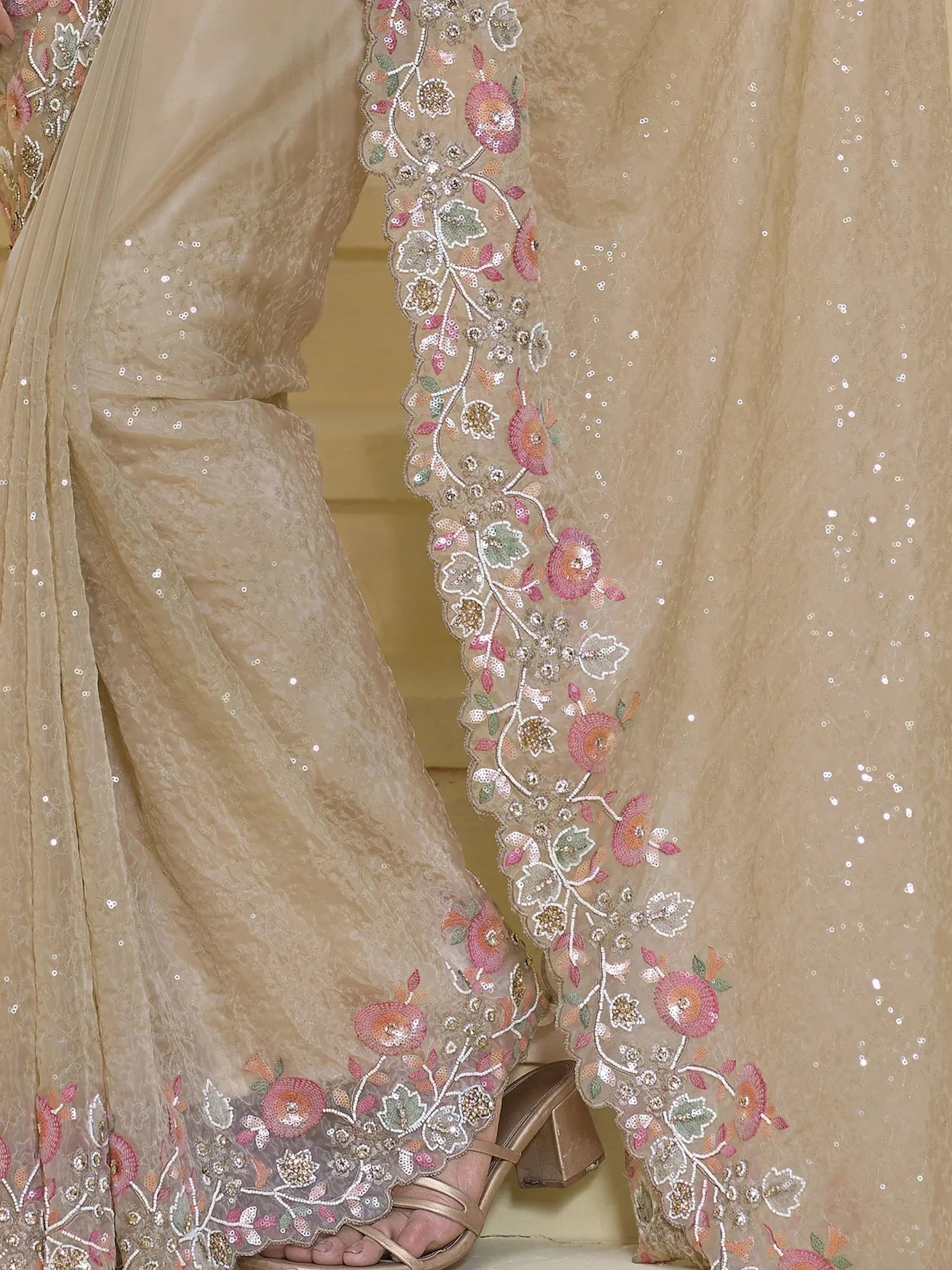 Beige ethnic salwar kameez with floral embroidery and sequin detailing, perfect for Indian occasions.