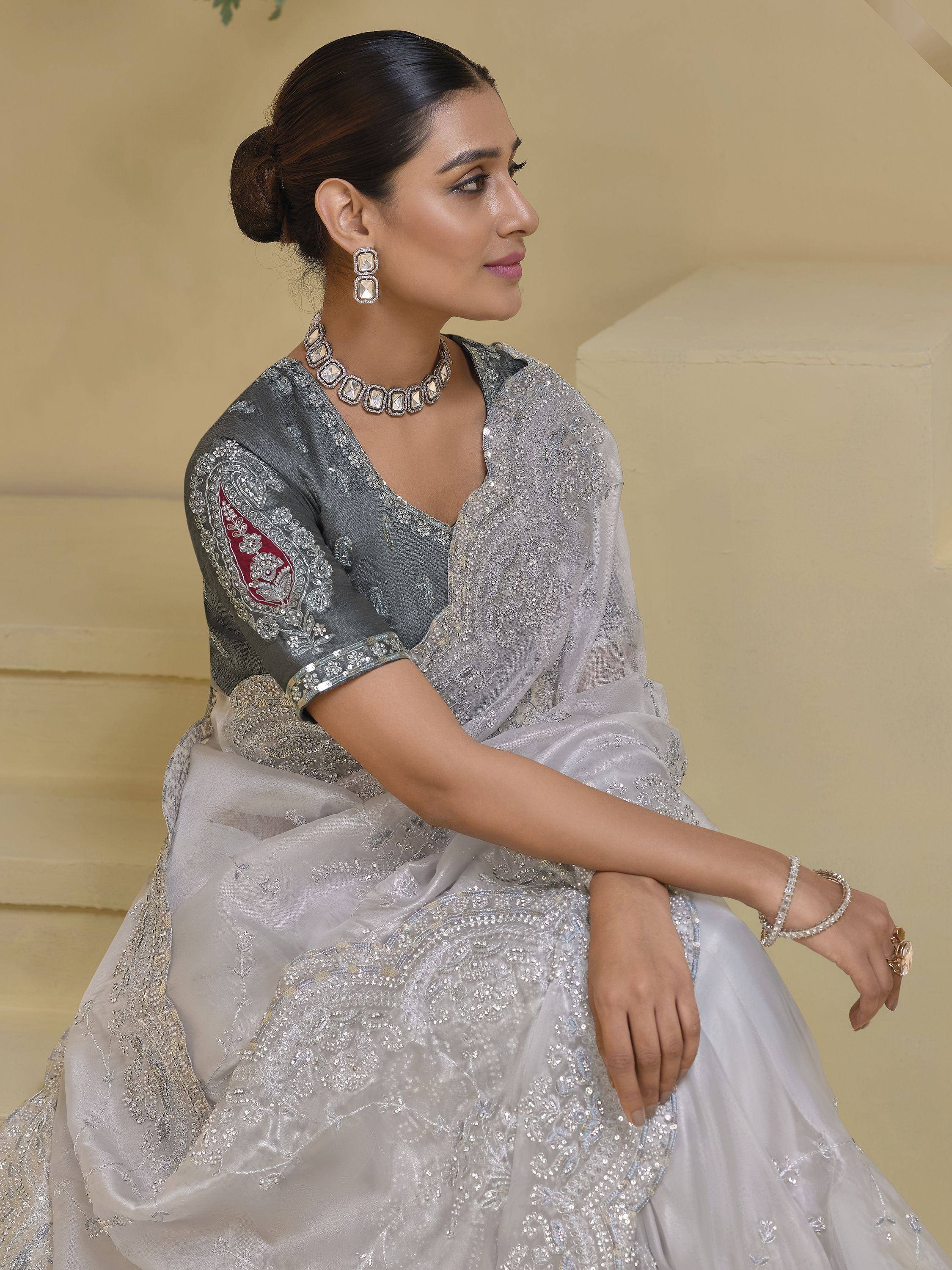 Elegant silver-grey embroidered lehenga choli with red accent, perfect for Indian ethnic wear occasions.
