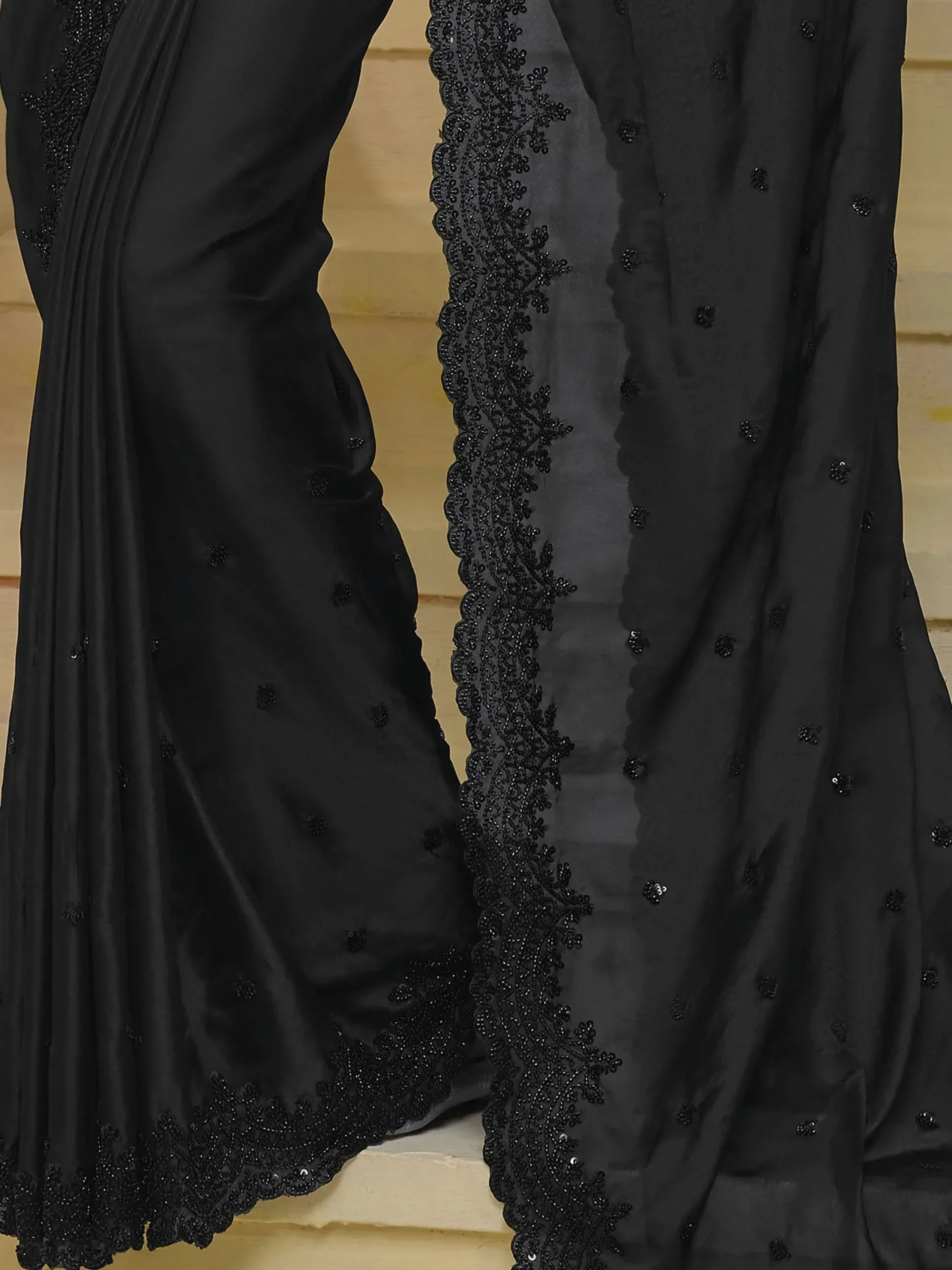 Black designer saree with intricate beadwork and lace border, perfect for ethnic occasions.