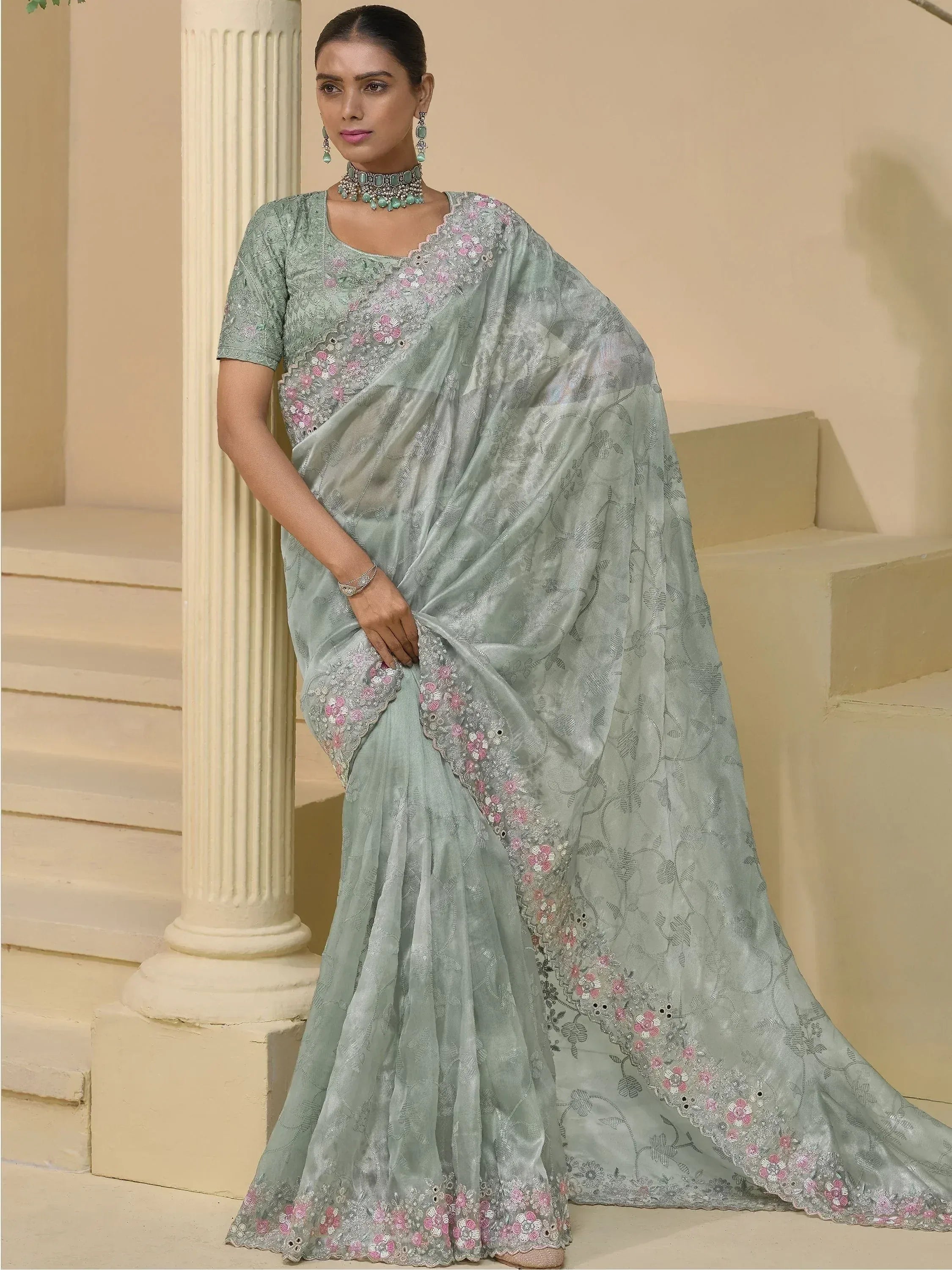 Mint green embroidered saree with floral detailing, perfect for Indian ethnic wear occasions.