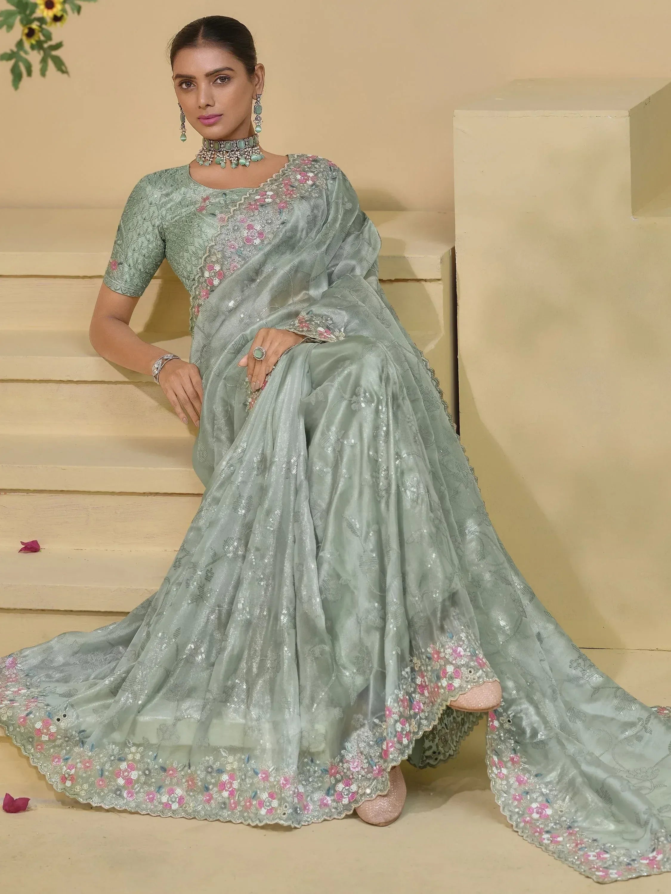 Mint green designer saree with floral embroidery and sequins, perfect for Indian ethnic occasions.