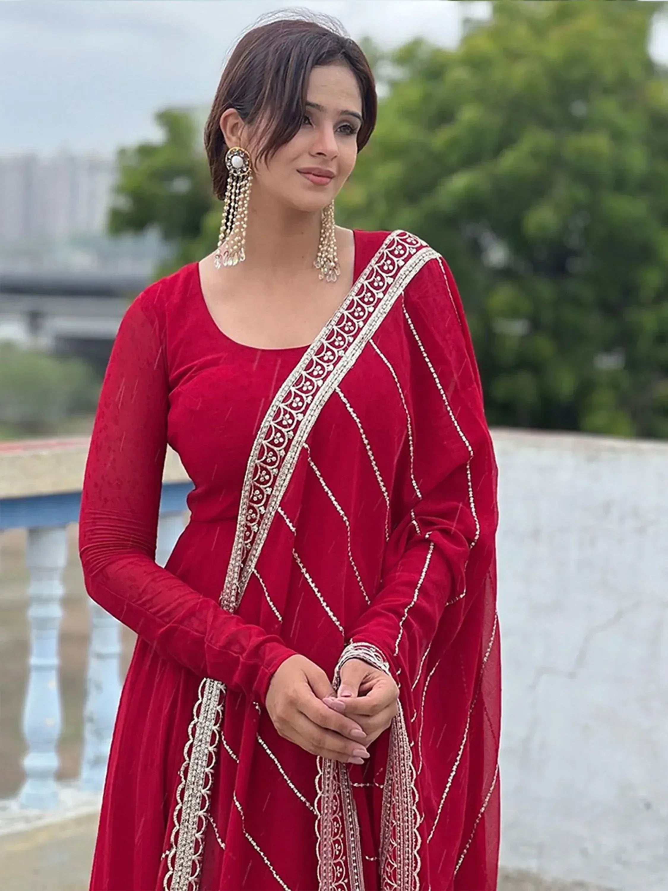 Red velvet ethnic gown with silver embroidery, perfect for Indian weddings and festive occasions.
