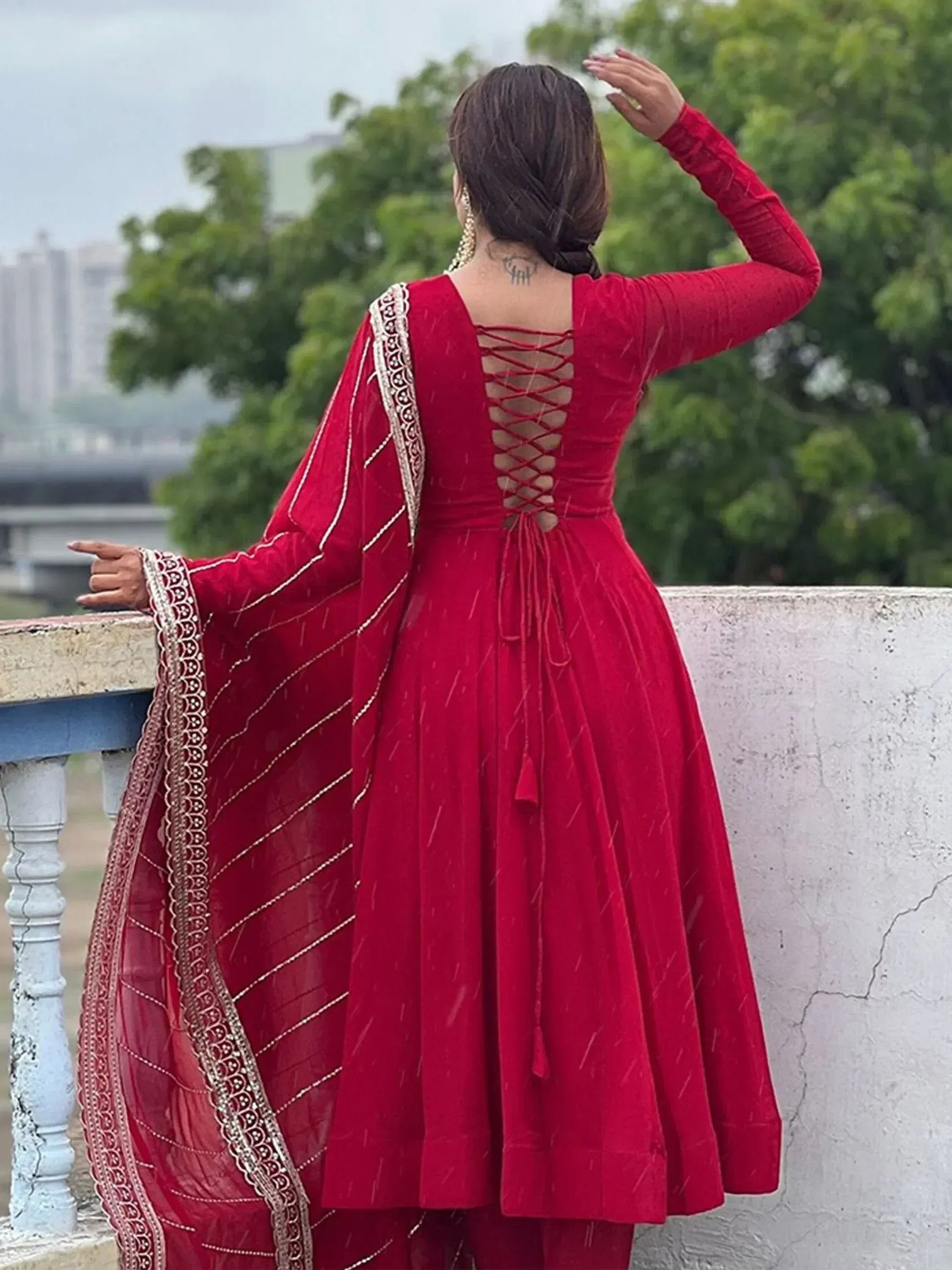 Red velvet ethnic gown with lace-up back and embroidered dupatta, perfect for Indian celebrations
