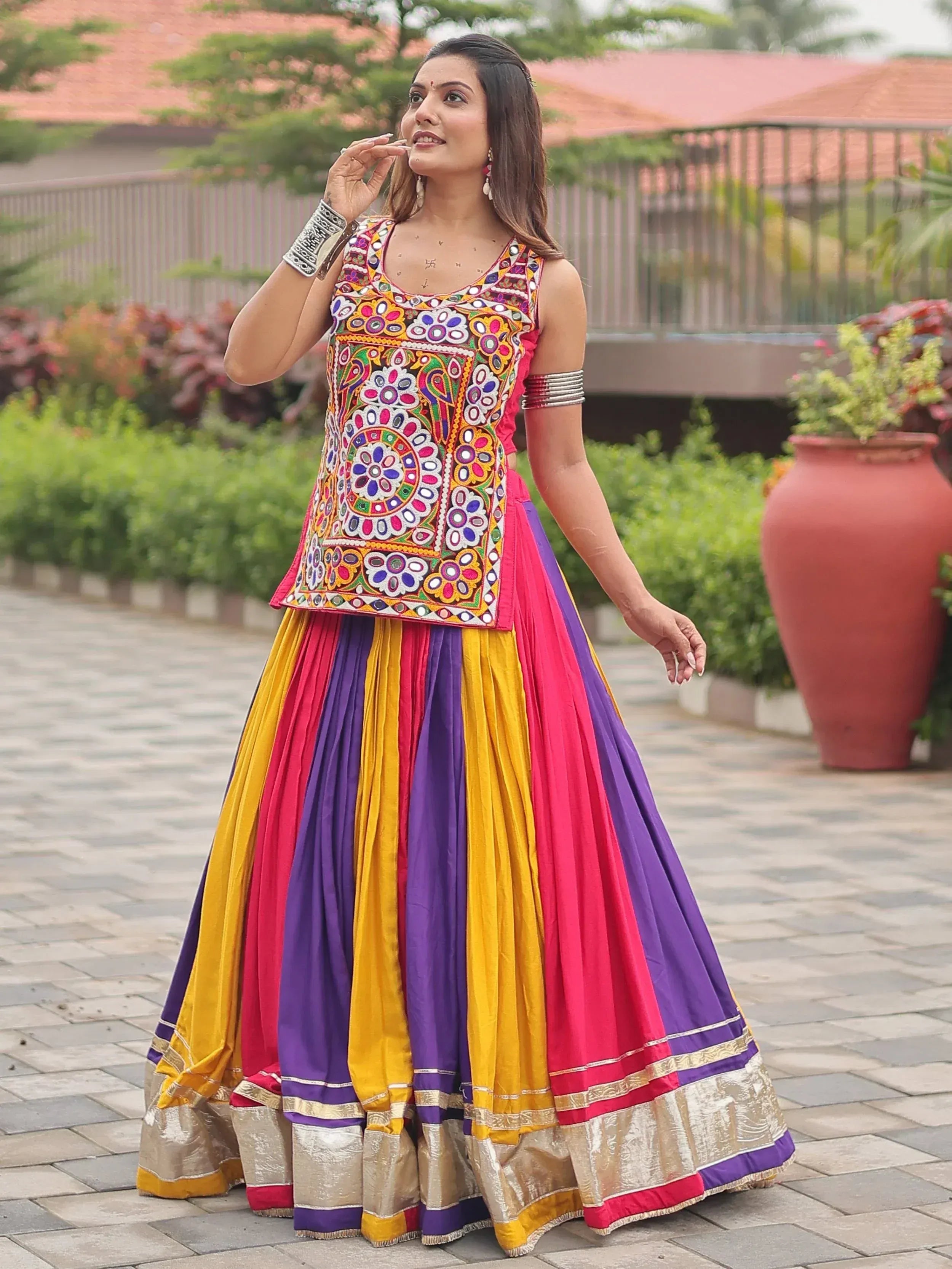 Woman in colorful embroidered Indian lehenga choli with mirror work, perfect for festive occasions