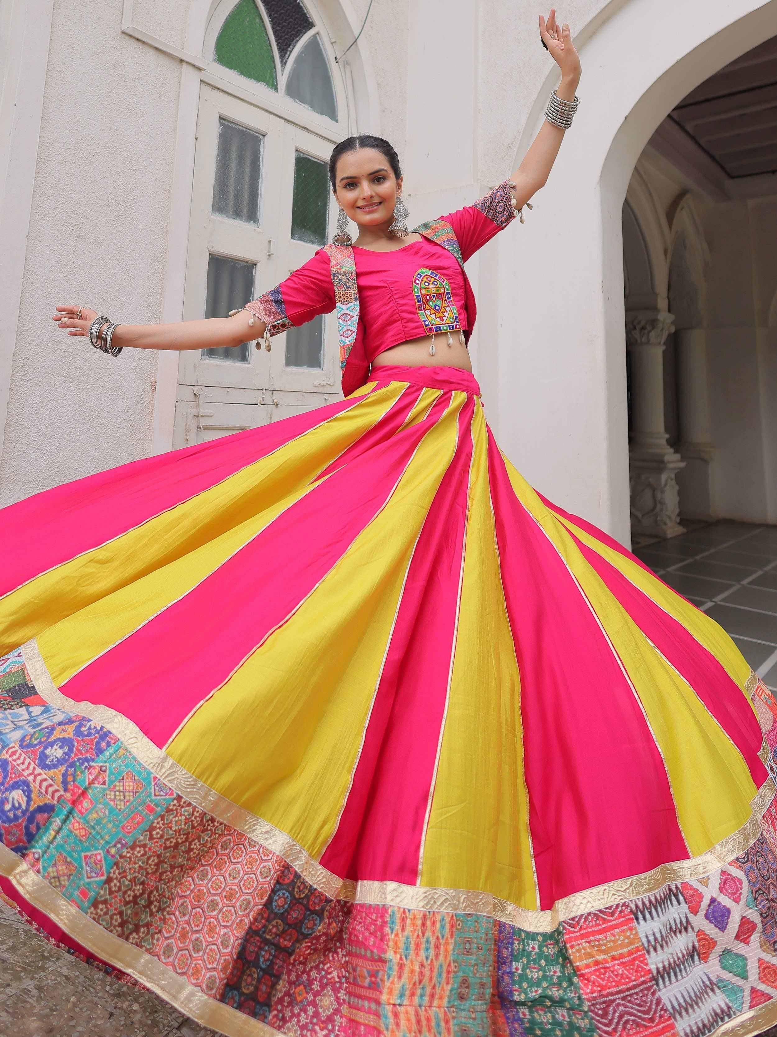 Vibrant pink and yellow ethnic lehenga choli with embroidered blouse, perfect for Indian festivals and celebrations.