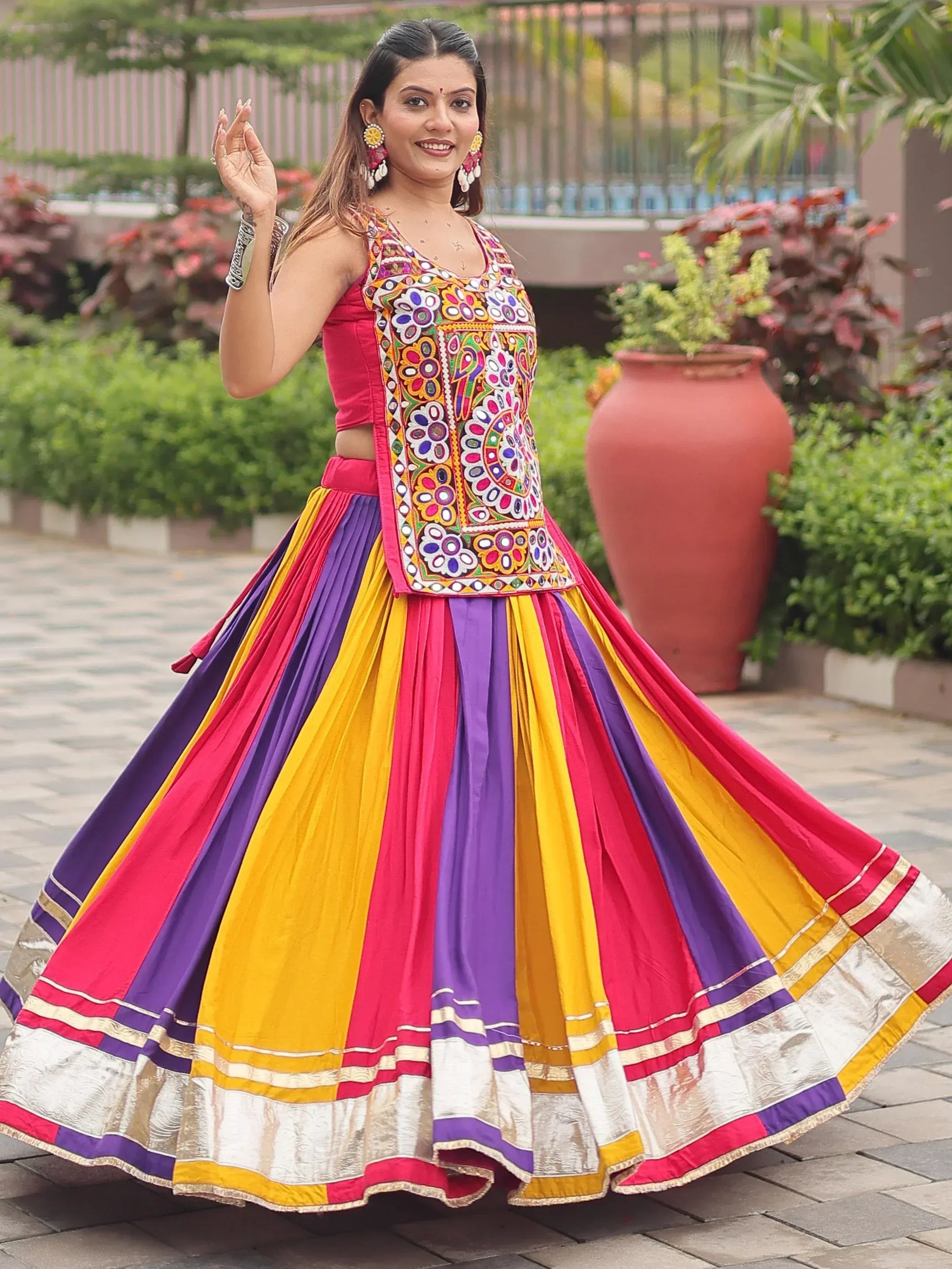 Vibrant Indian ethnic lehenga choli with colorful striped skirt and embroidered blouse, perfect for festive occasions.