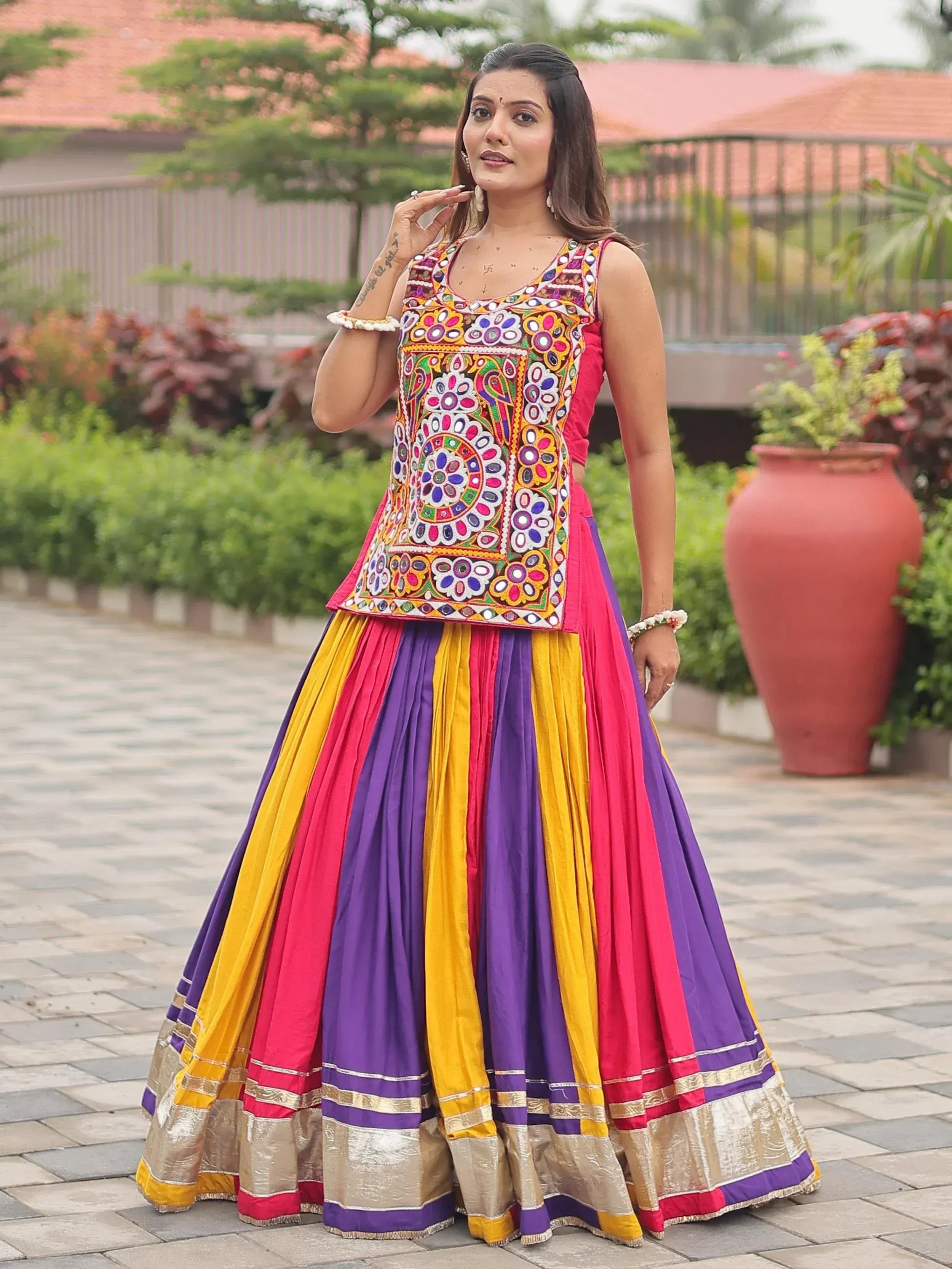 Colorful embroidered lehenga choli with vibrant stripes and floral patterns for festive occasions