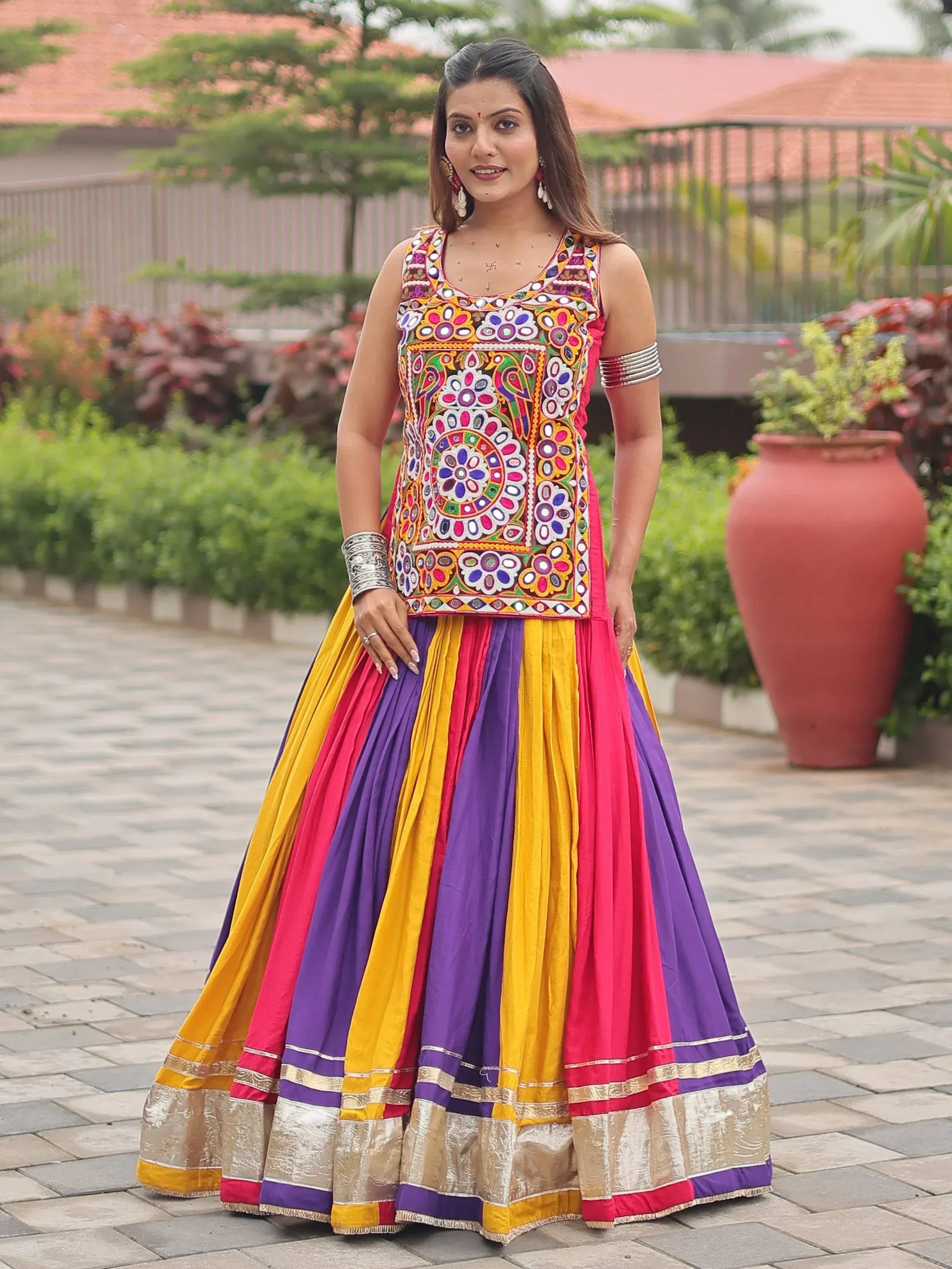 Colorful Indian ethnic lehenga choli with mirror work and striped skirt, perfect for festive occasions