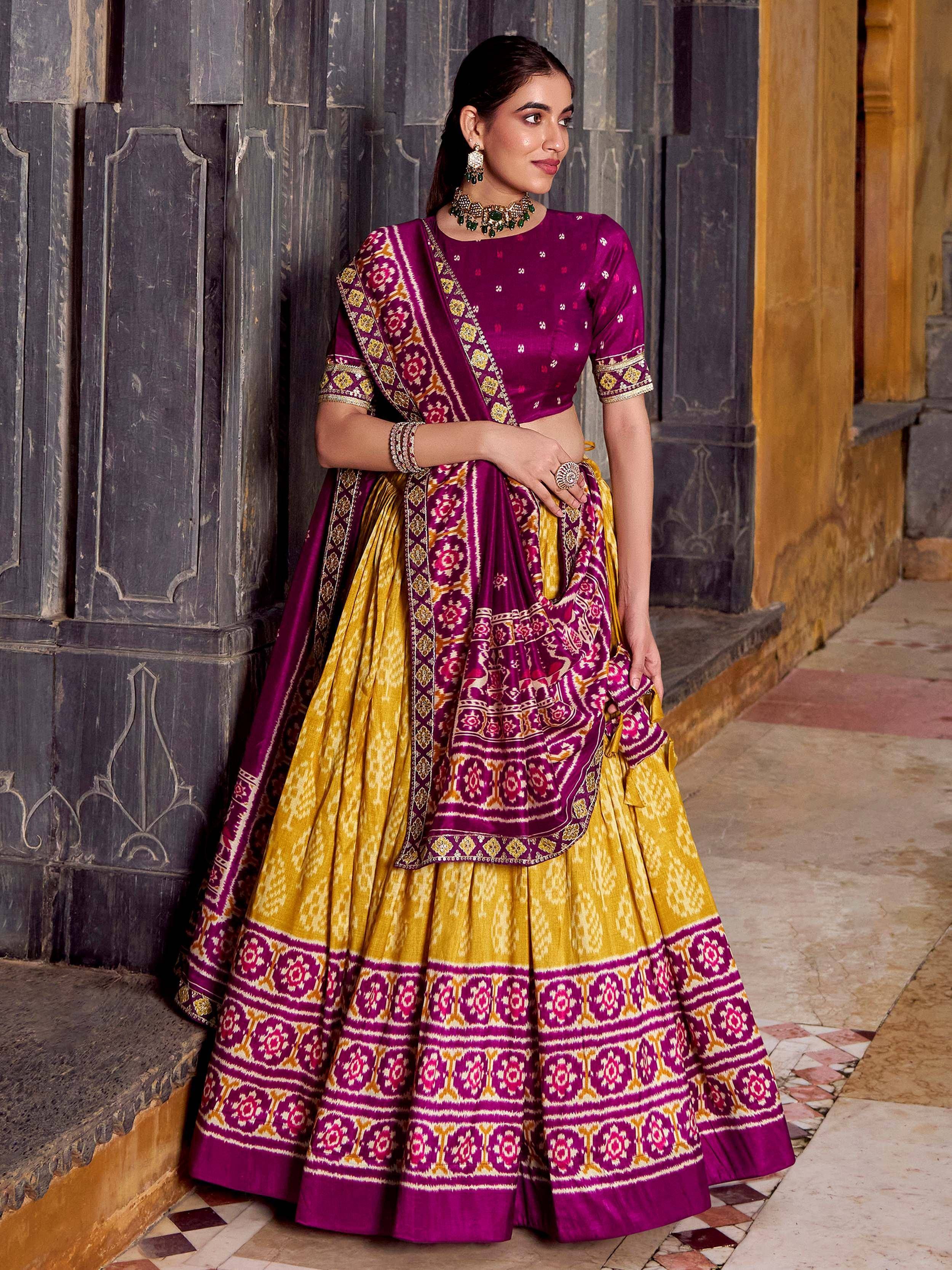 Purple and gold designer lehenga choli with intricate ikat patterns, perfect for Indian ethnic wear occasions.