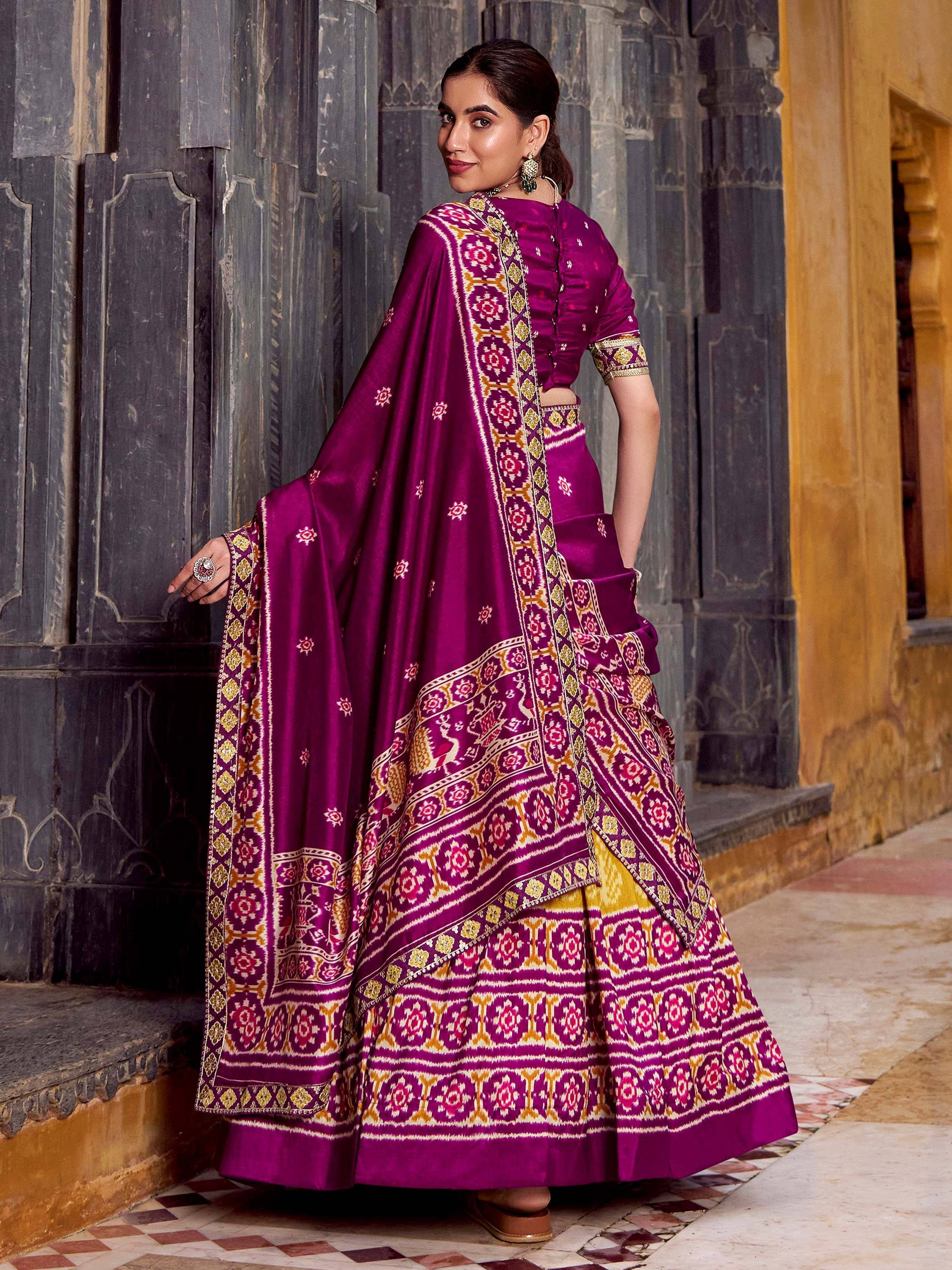 Purple designer lehenga choli with intricate gold and pink embroidery, perfect for Indian ethnic wear