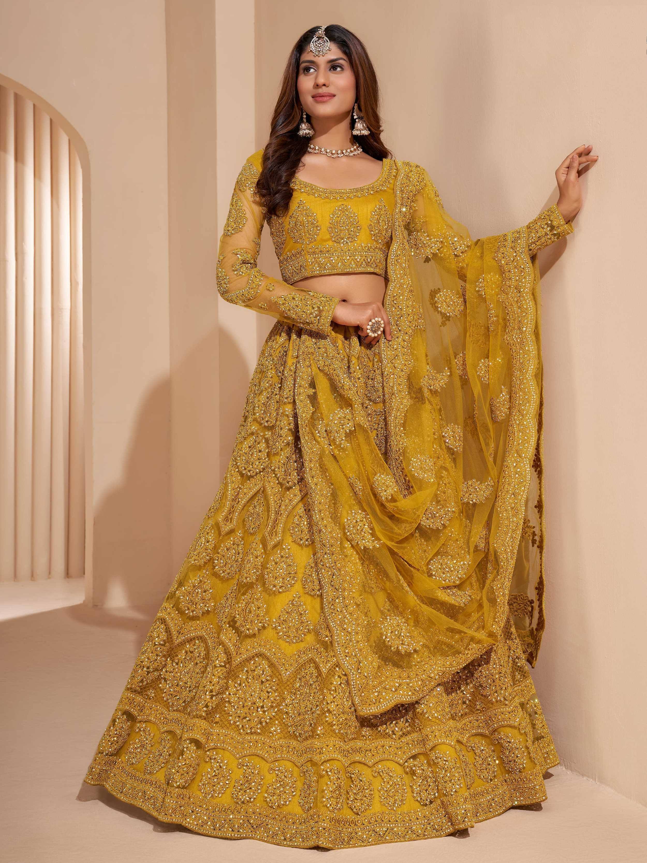 Yellow embroidered lehenga choli with heavy embellishments and sheer dupatta for Indian ethnic wear