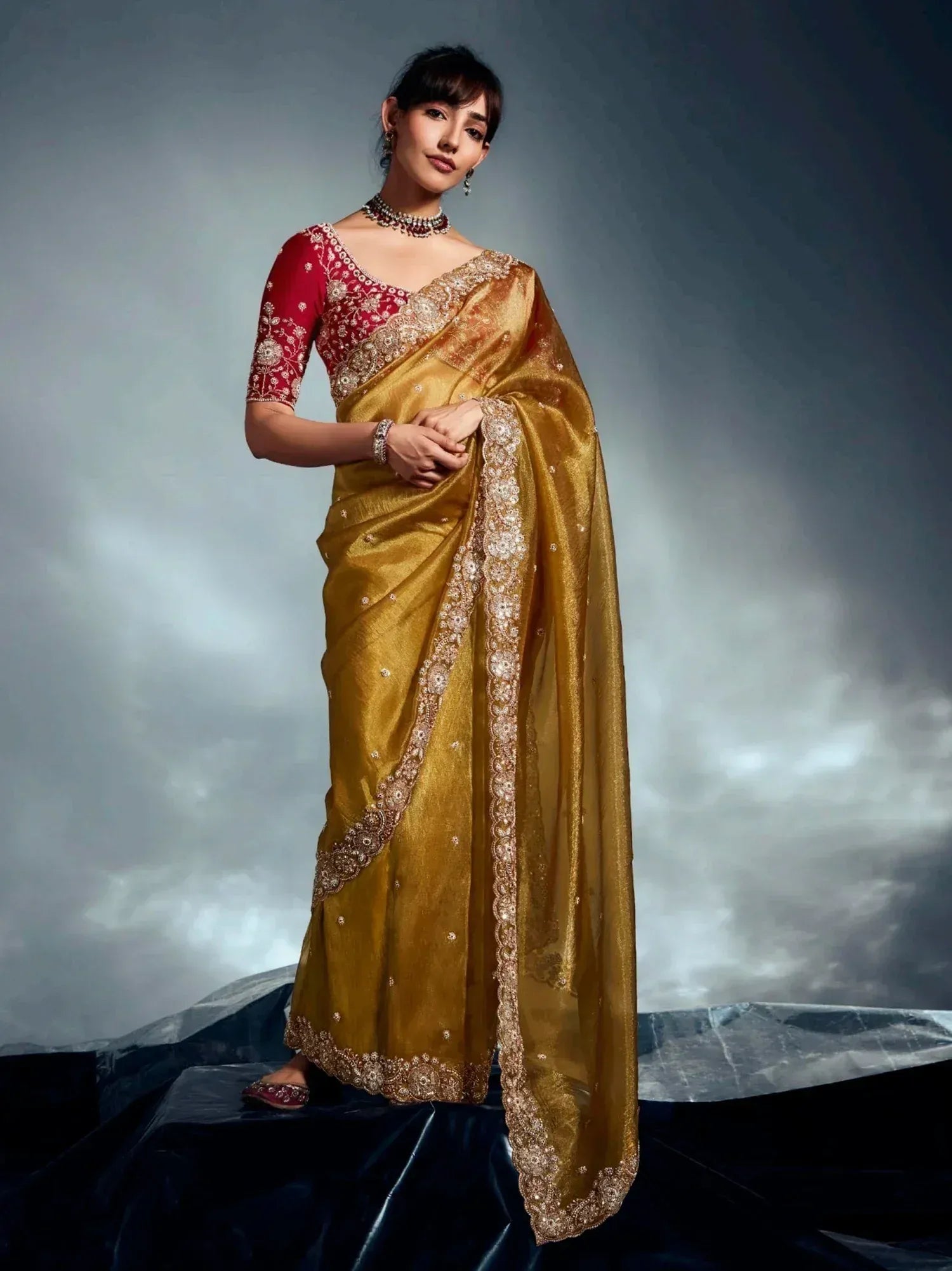 Golden embroidered saree with red blouse, perfect for Indian ethnic wear and festive occasions.