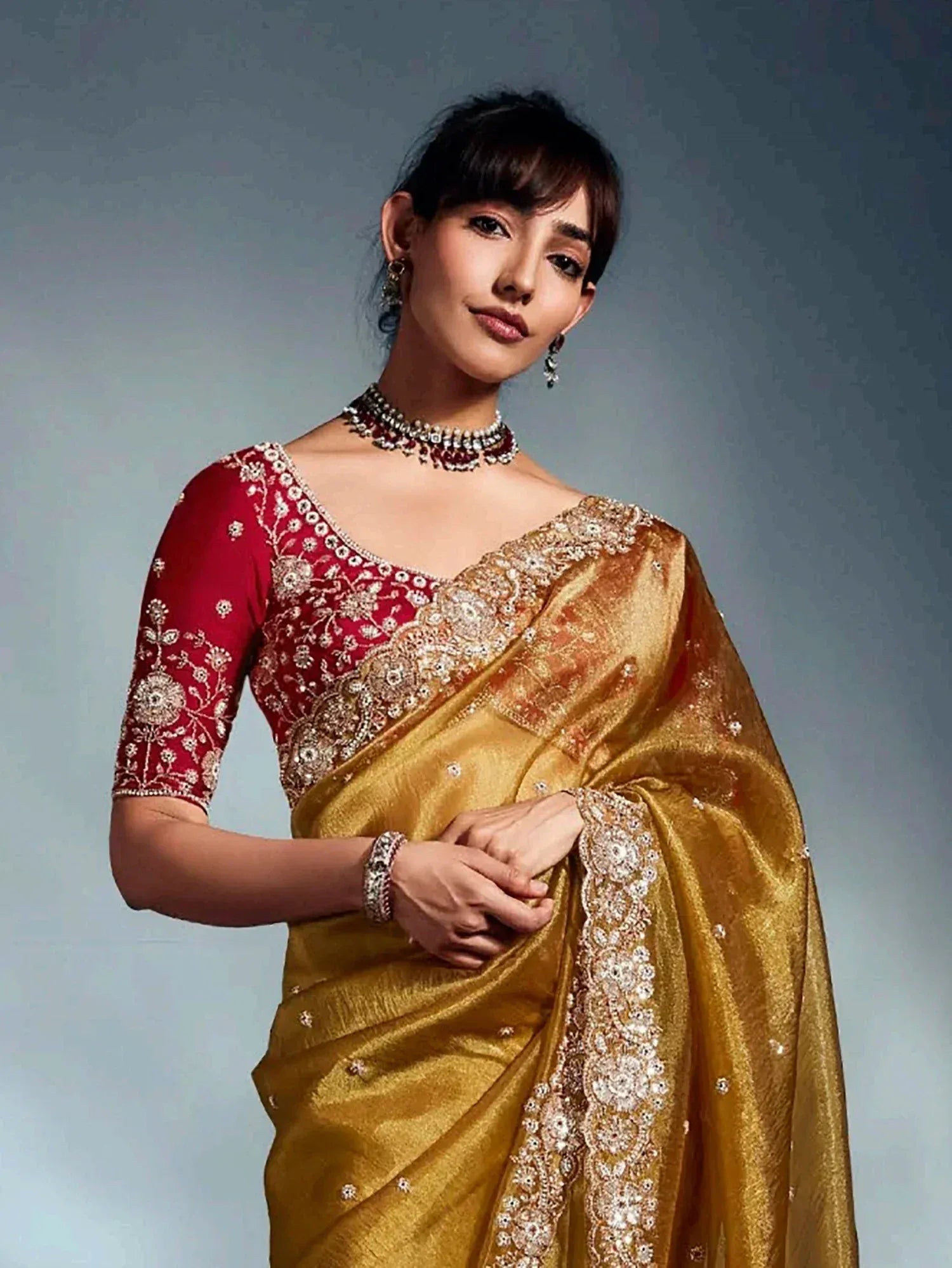 Golden embroidered saree with red blouse, perfect for Indian ethnic wear and festive occasions.